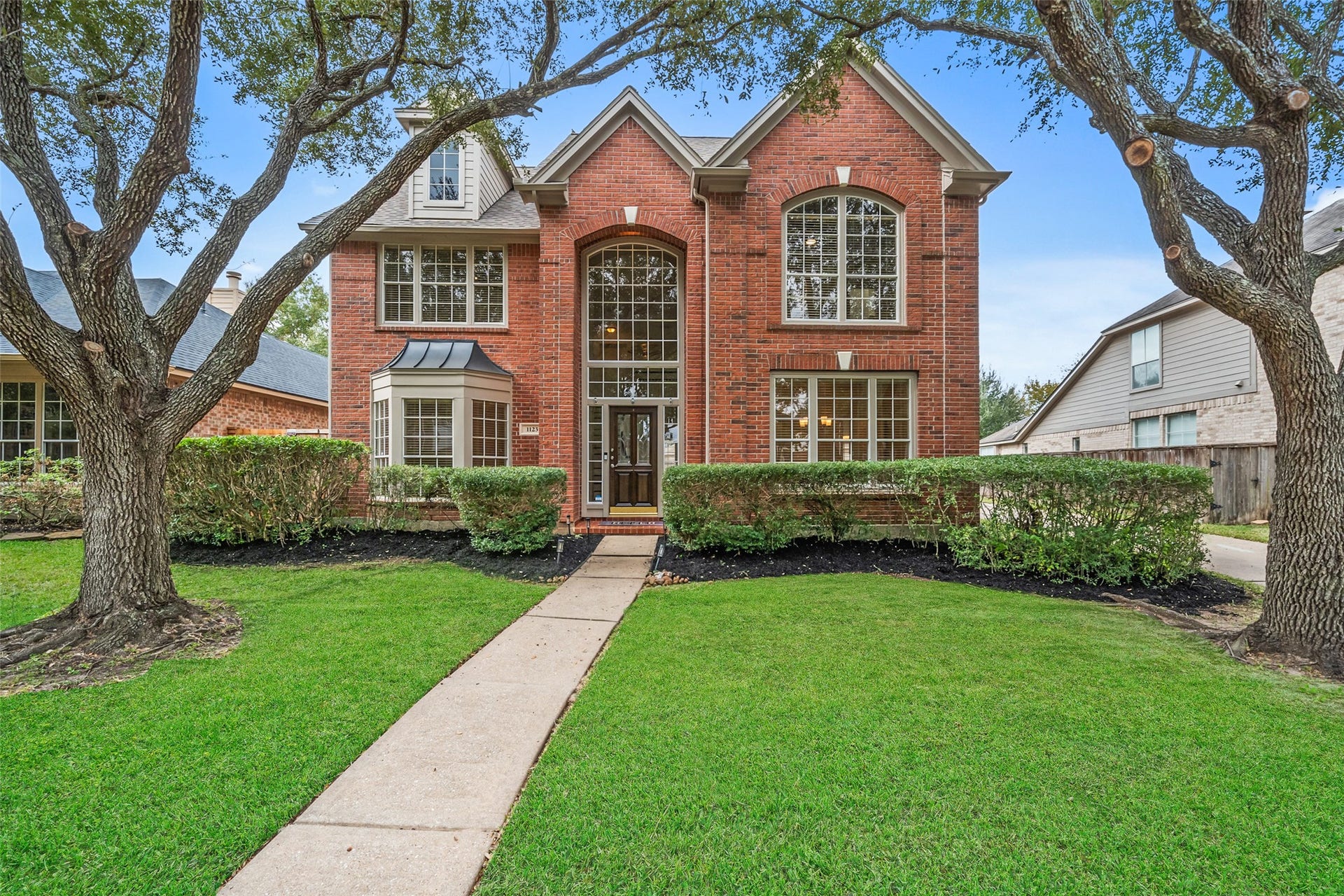 1123 Summer Brook, Sugar Land, TX 77479 A timeless brick faade welcomes you home with storybook charm, framed by mature trees and a manicured lawn that sets the tone before you ever step inside. The inviting front entry creates a warm first impression, offering a sense of arrival that feels both elegant and comfortingwhere everyday living begins to feel just a little more special.