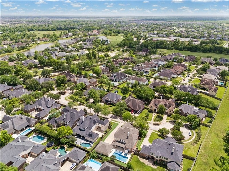 9007 Avebury Stone Circle, Missouri City, TX 77459 Here's another aerial view showcasing the propertys prime location in Sienna, nestled within a tree-lined, amenity-rich community surrounded by upscale homes and just minutes from area schools, shopping, and dining.
