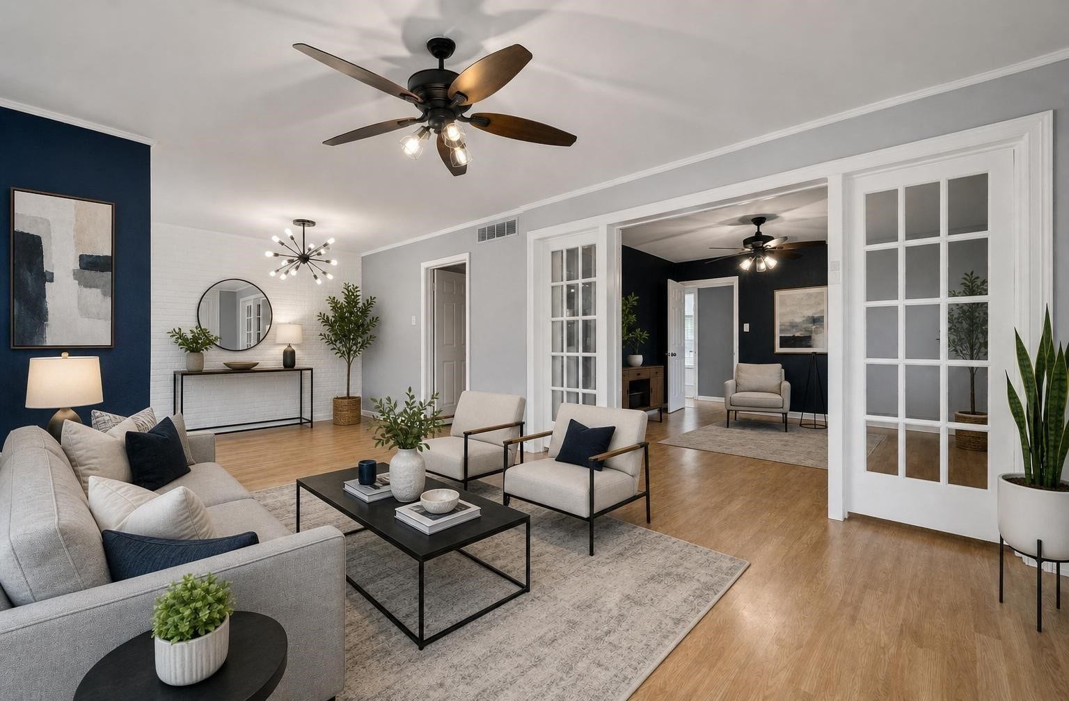 2615 Marilee Lane, #2, Houston, TX 77057 Living room showcasing the inviting layout, laminate flooring, ceiling fan, and French doors opening toward the private balcony. Some pictures have been virtually staged