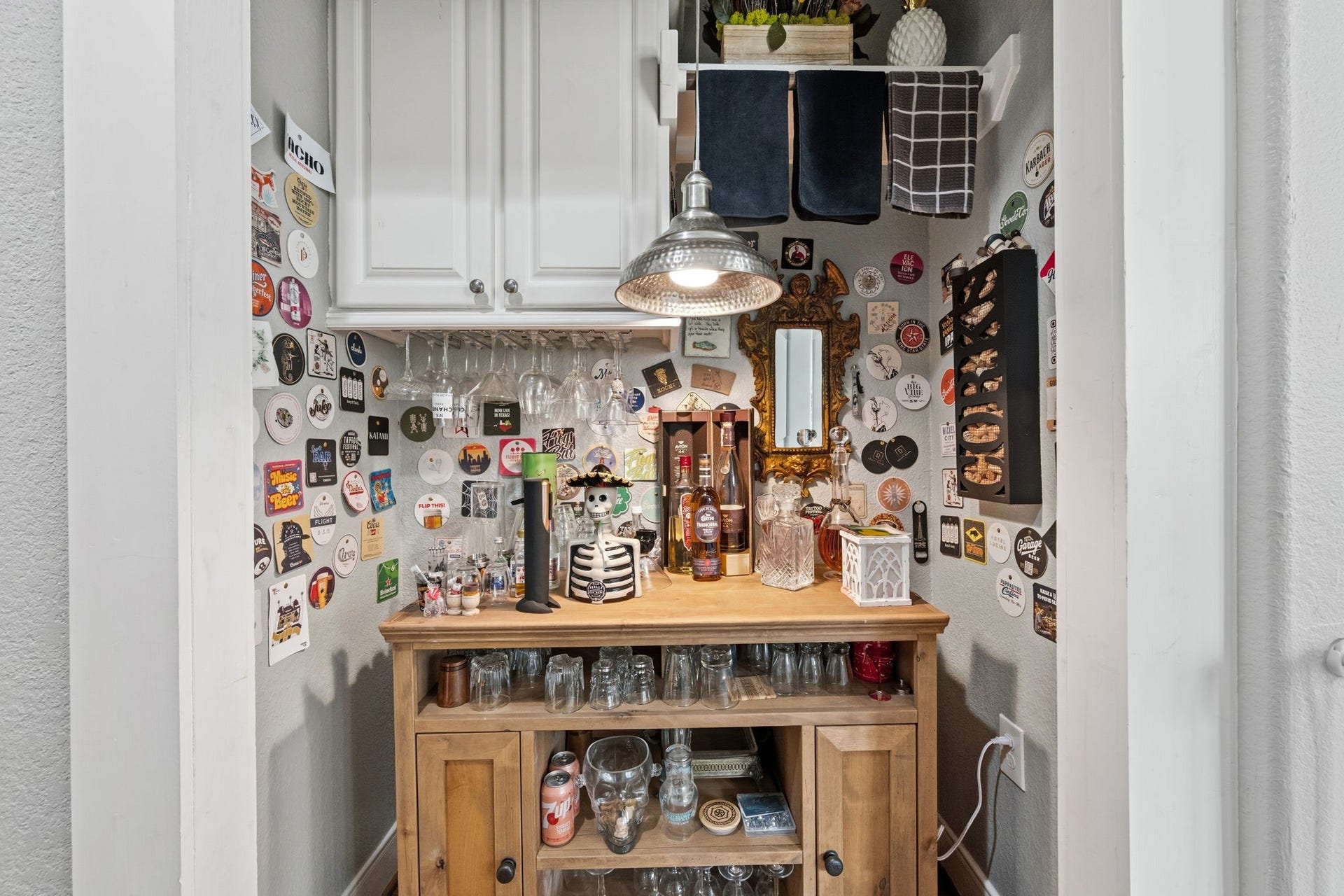 A built in bar and pantry shelving off the kitchen.