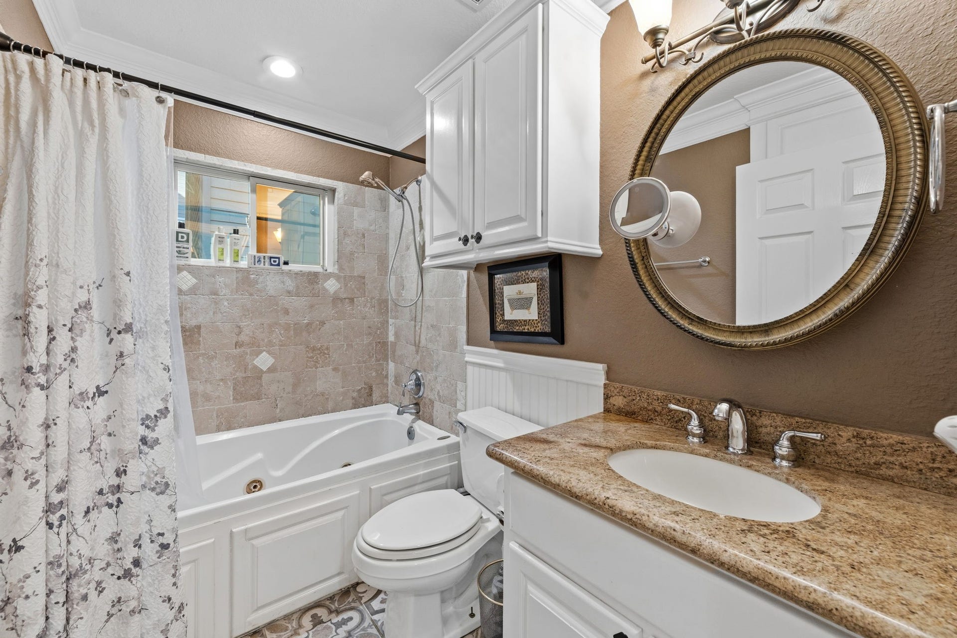 Tile work and a round mirror give the bath character.