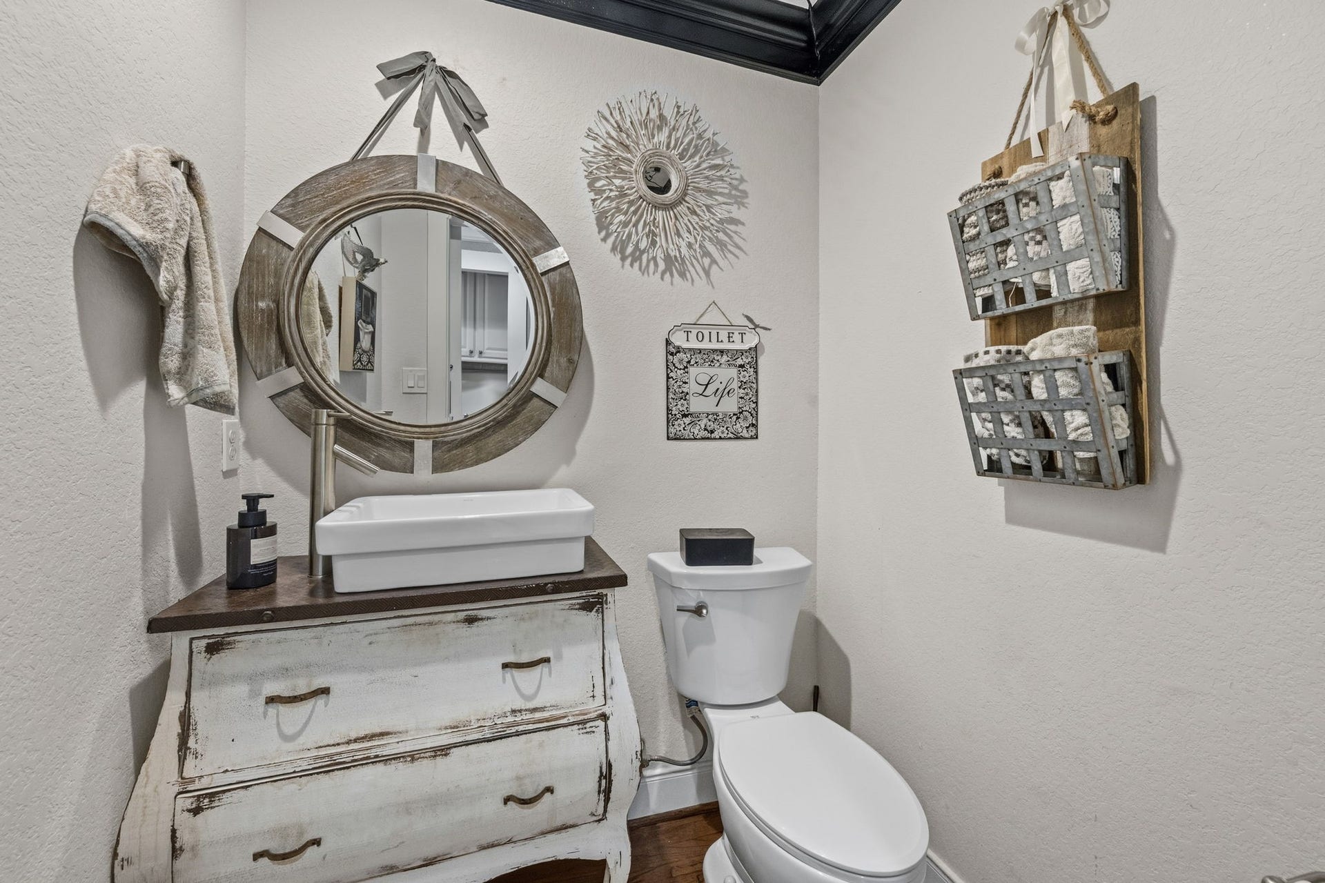 A powder bath with a decorative mirror.