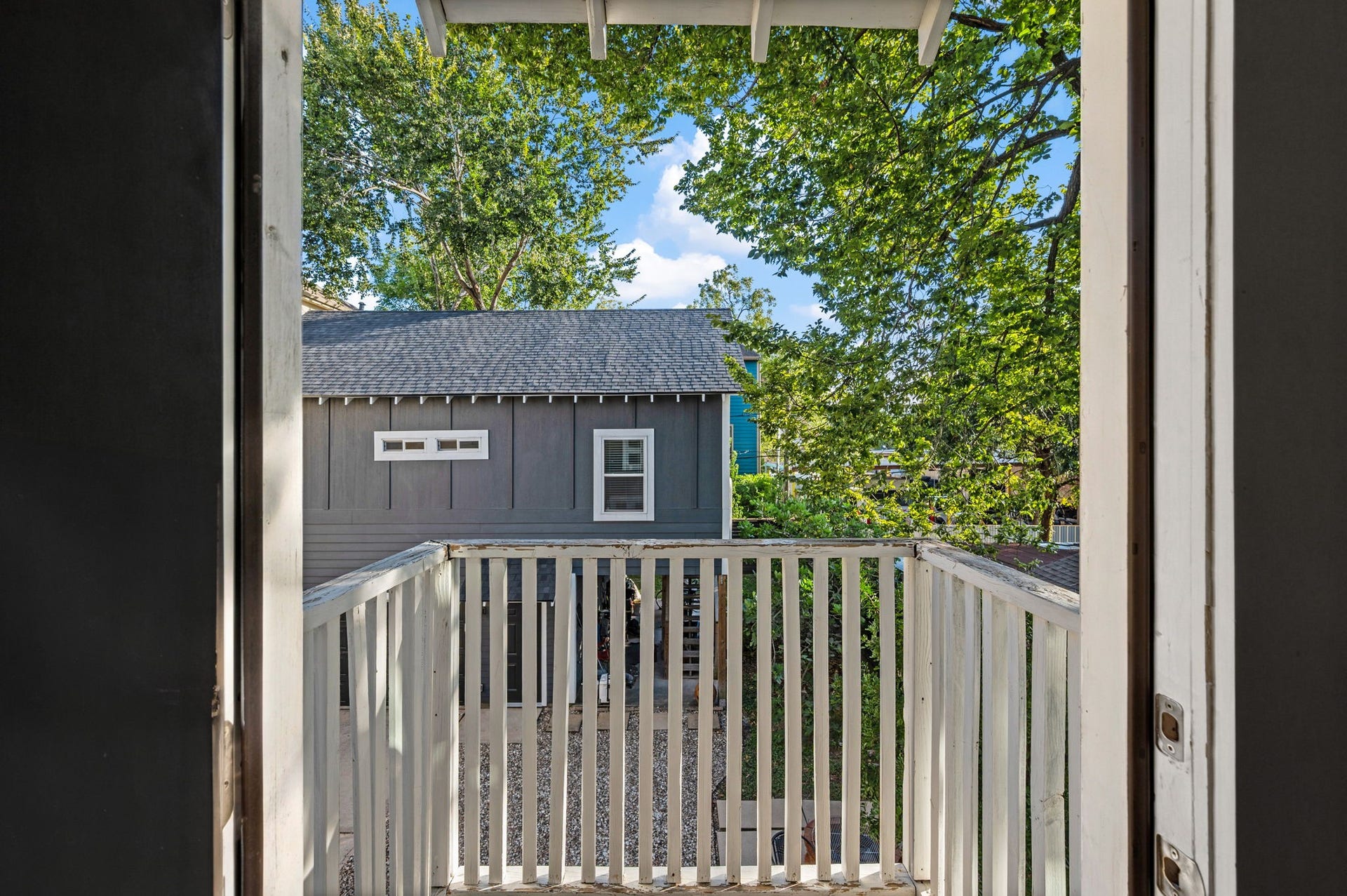 A covered deck off the back of the home.