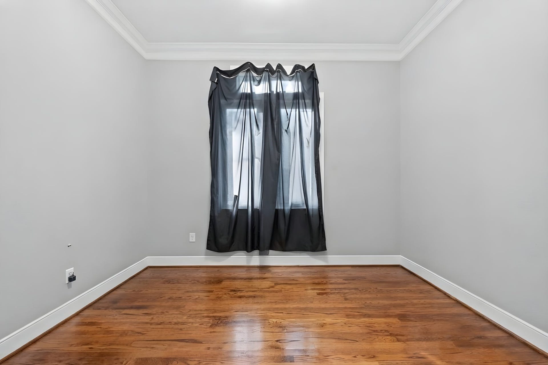 A flexible room with tall windows and crown molding.