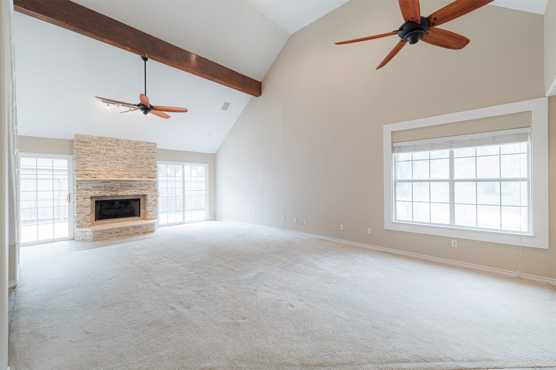 519 E Hillary Circle, Sugar Land, TX 77498 The expansive family room featuring a striking stone surround gas-log fireplace.
