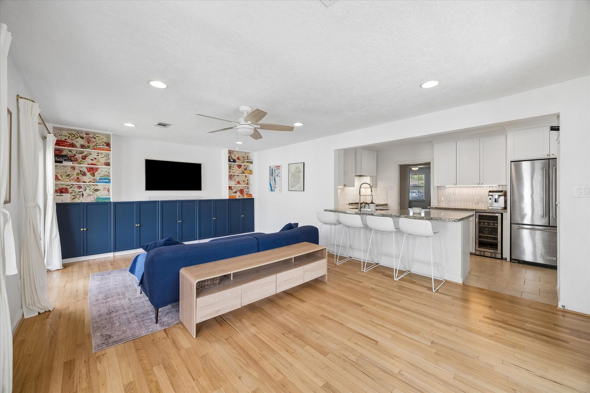 1232 Chantilly Lane, Houston, TX 77018 Open concept family room connects seamlessly to the kitchen, featuring custom built ins, hardwood flooring, and a generous breakfast bar designed for casual seating and entertaining.