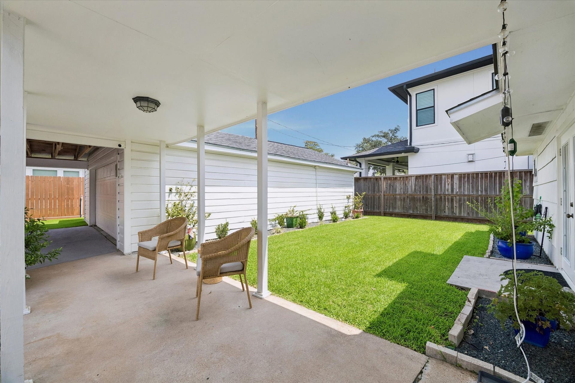 1232 Chantilly Lane, Houston, TX 77018 Covered back patio overlooking a spacious fenced yard, creating a private outdoor space for relaxing, entertaining, or play.