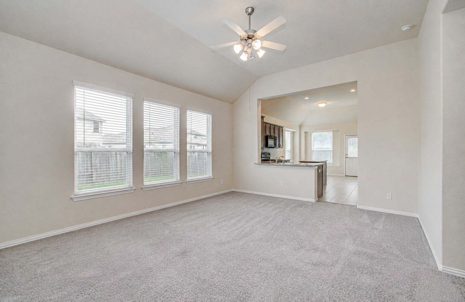 3403 Brazos Falls Dr, Richmond, TX 77469 Open-concept living area that flows into the kitchen, with fresh neutral paint and carpet.