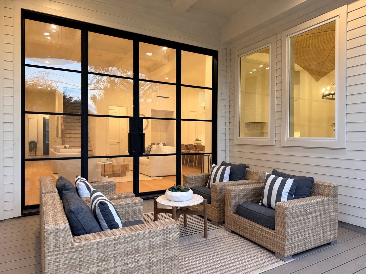 Enjoy the outdoors in style with this spacious covered patio. Perfect for relaxing with a morning coffee or hosting evening gatherings, it seamlessly extends your living space into the open air. Its generous dimensions accommodate lounge furniture or a dining set. -  This is a conceptual rendering - The property is currently under construction, estimated completion March 2027. Design, materials and finishes are illustrative and subject to change. Visit our staged home at 1002 E. 25th Street.