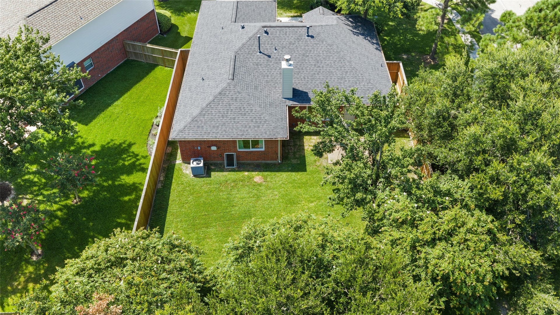 3001 Meadow Bay Drive, Dickinson, TX 77539 Charming brick home with a spacious, lush backyard and mature trees, perfect for outdoor activities and relaxation.