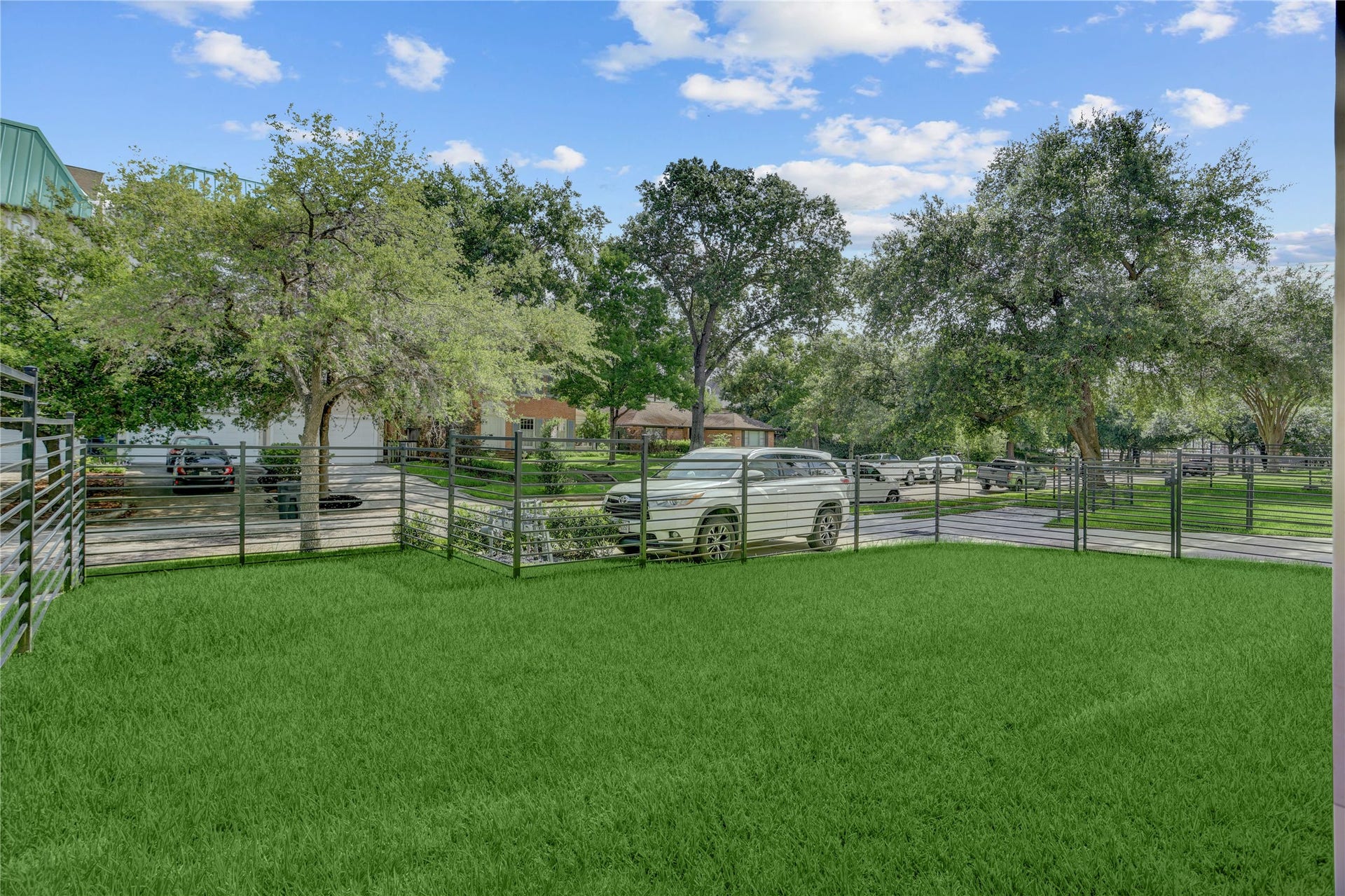 1907 Lauderdale Street, Houston, TX 77030 View from 1907 Lauderdale of the fully-fenced yard space with gated access from the driveway or directly from the house.