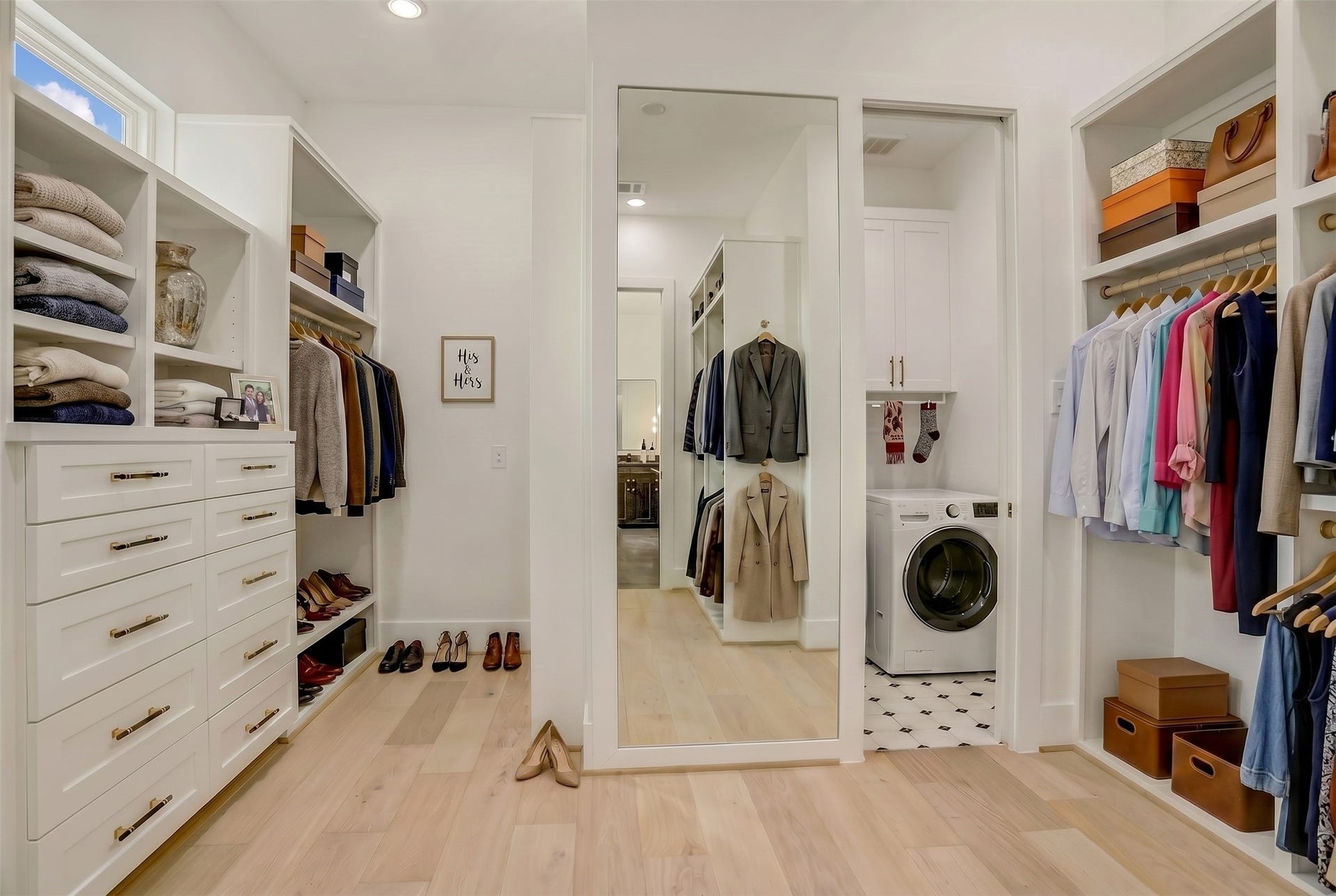 1907 Lauderdale Street, Houston, TX 77030 The primary closet, complete with built-ins and a full-length mirror, also allows for direct access to the utility room. Virtually staged photo.