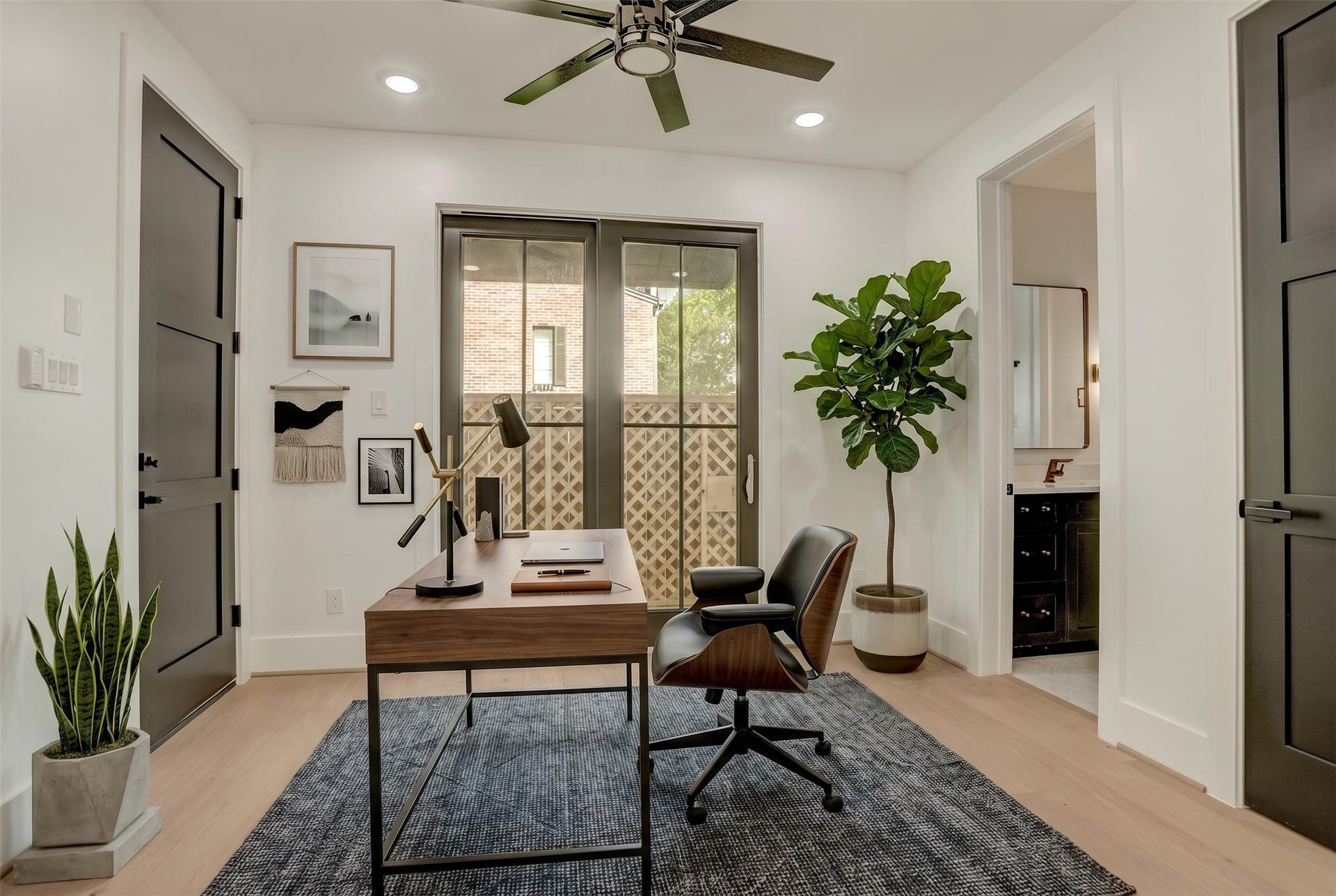 1907 Lauderdale Street, Houston, TX 77030 The first-floor study/bedroom 4 offers ensuite bathroom access and glass doors to the backyard. Virtually staged photo.