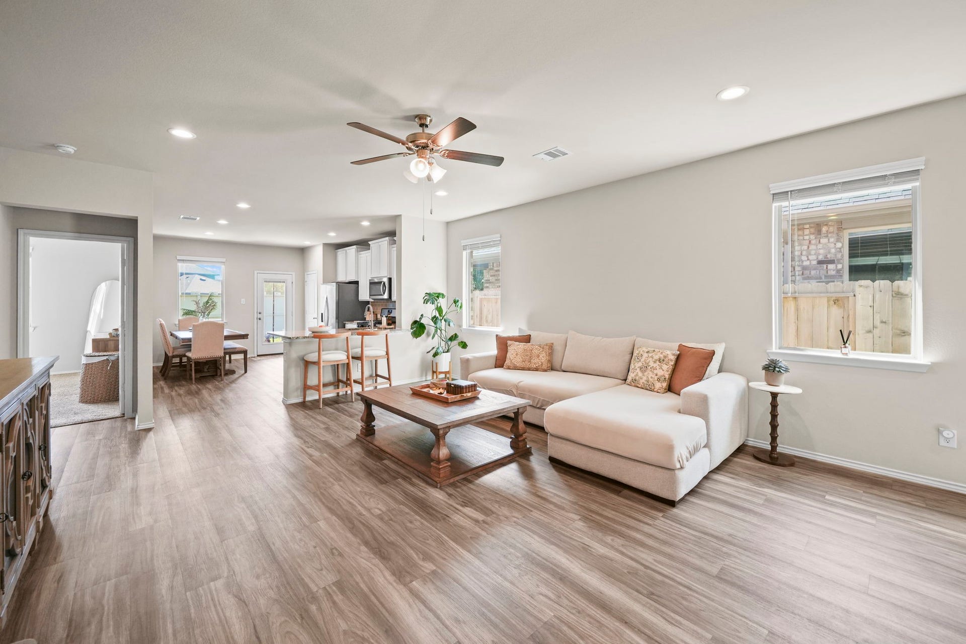 Inviting living room with natural light, warm wood-look flooring, and an open layout perfect for everyday living and entertaining.