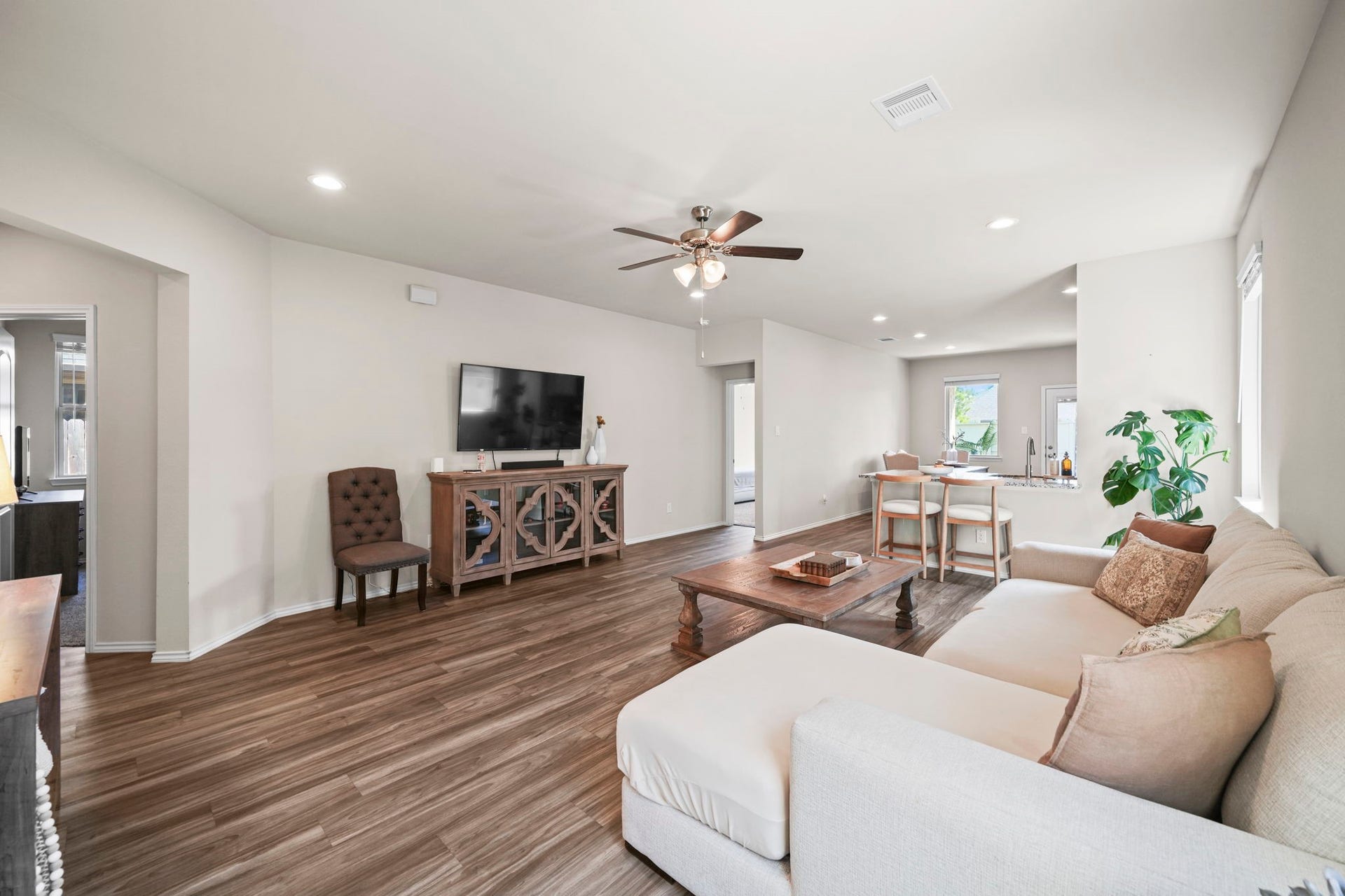 Spacious living room filled with natural light, offering a comfortable setting to relax, gather, and make memories.