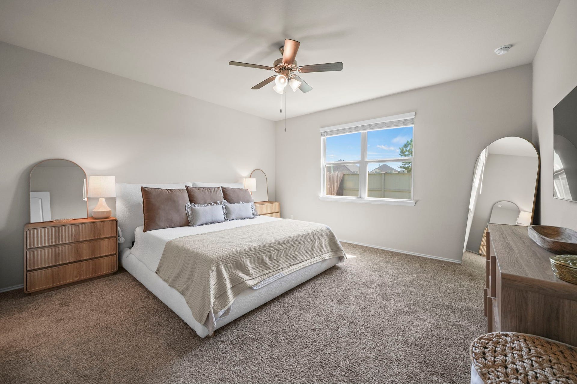 Comfortable primary bedroom offering a peaceful retreat with natural light and space to unwind.