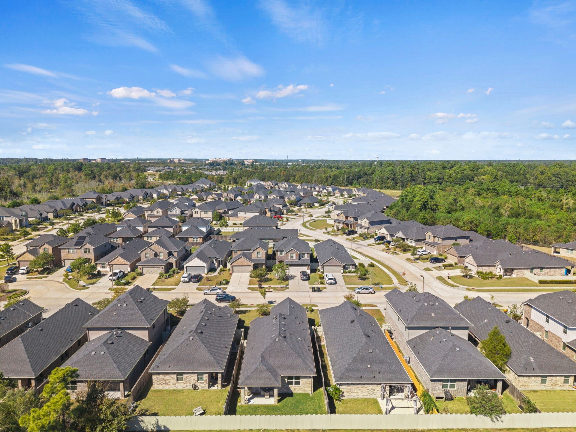 An aerial view highlighting the spacious backyard, covered patio, and outdoor space ready for relaxation and entertaining.