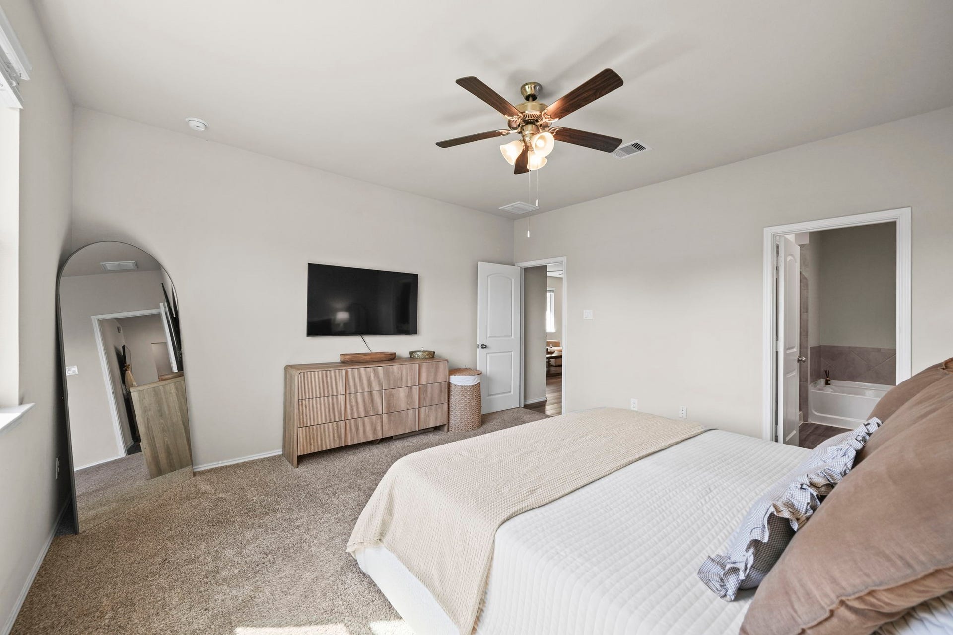A peaceful space to call your own, this primary bedroom offers a warm and comfortable setting to start and end each day.