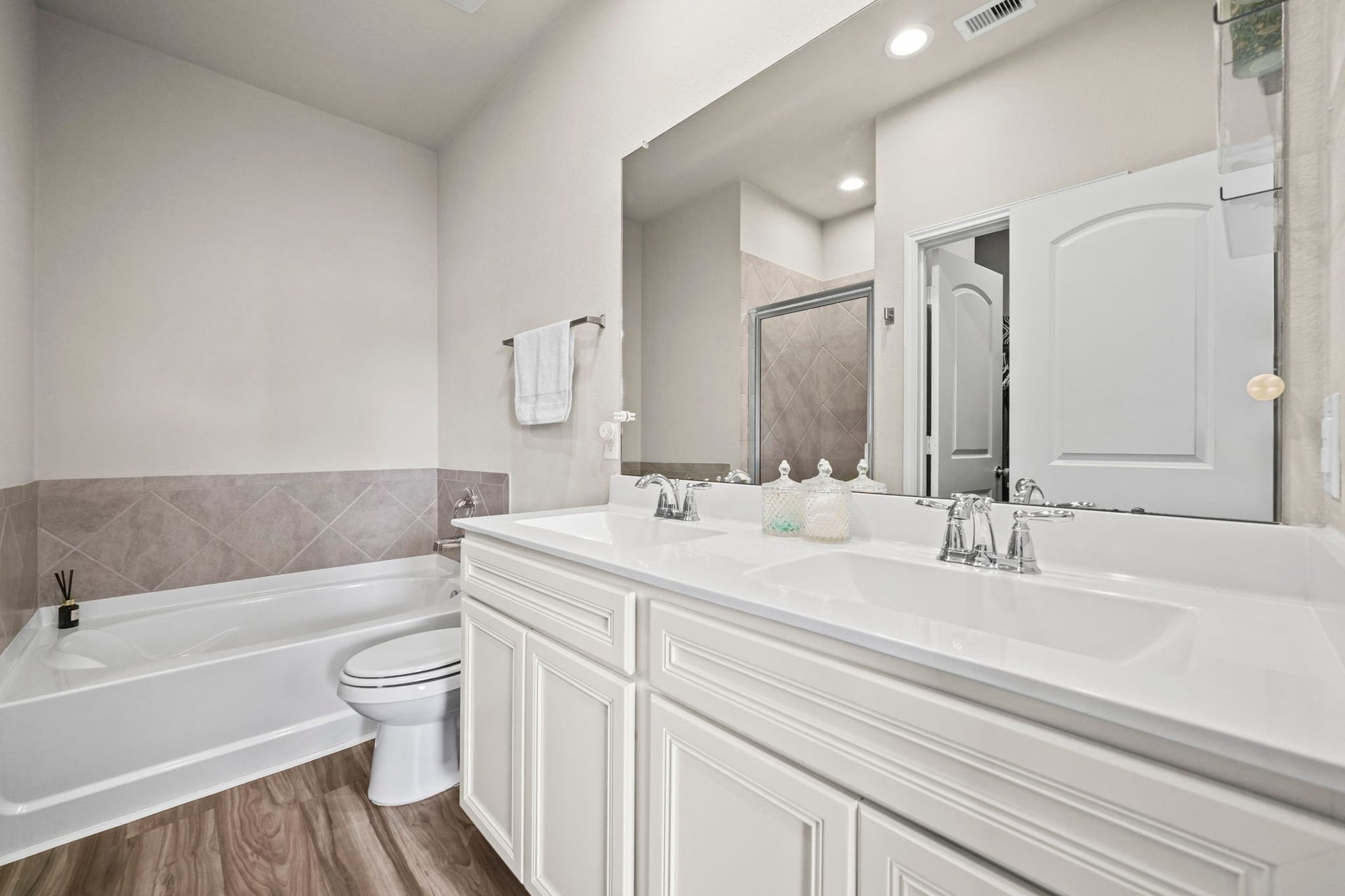 A thoughtfully designed primary bathroom offering comfort and convenience, with a relaxing space to refresh and unwind.