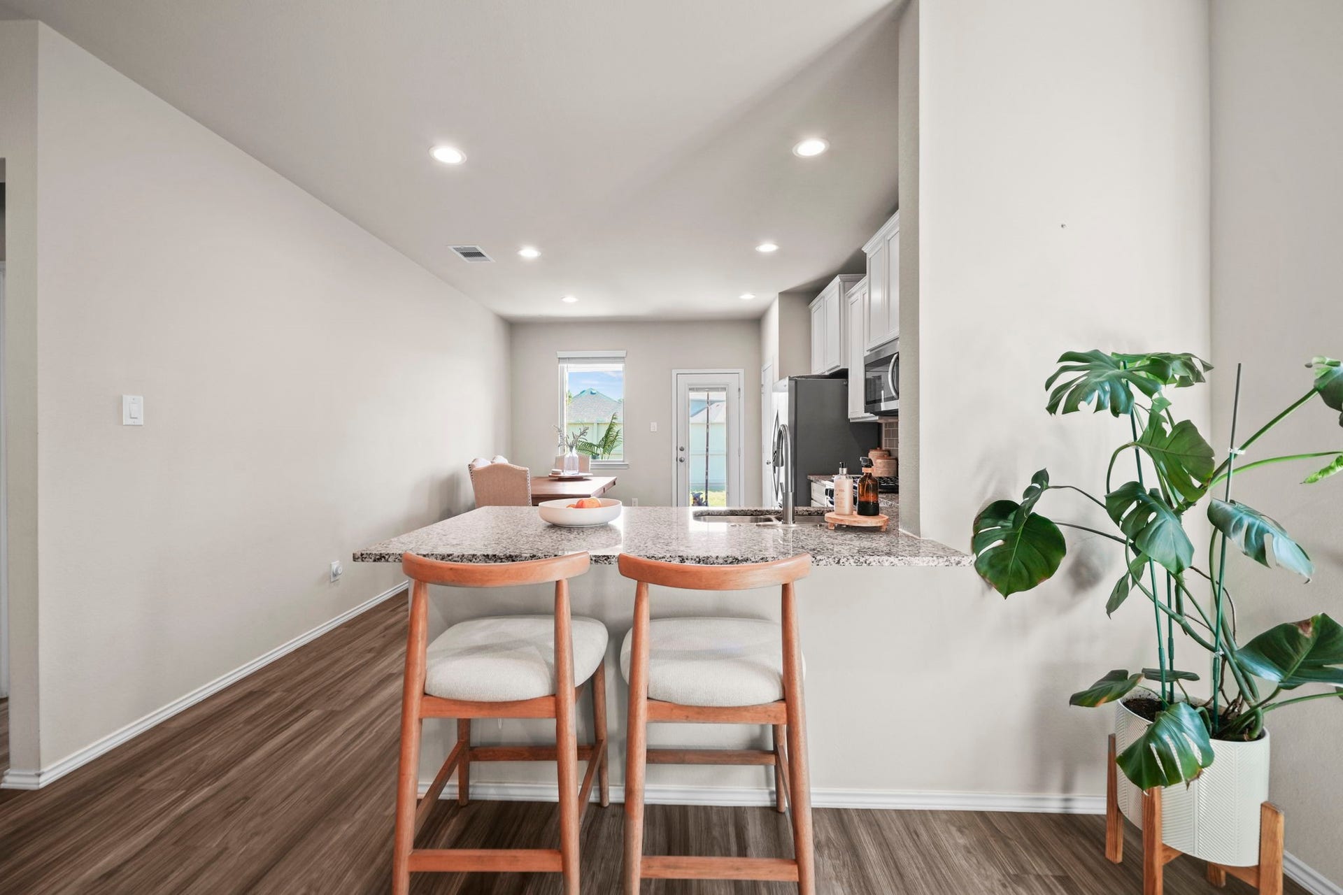 Generous kitchen counter space offers plenty of room for meal prep, casual dining, and gathering with family and friends.