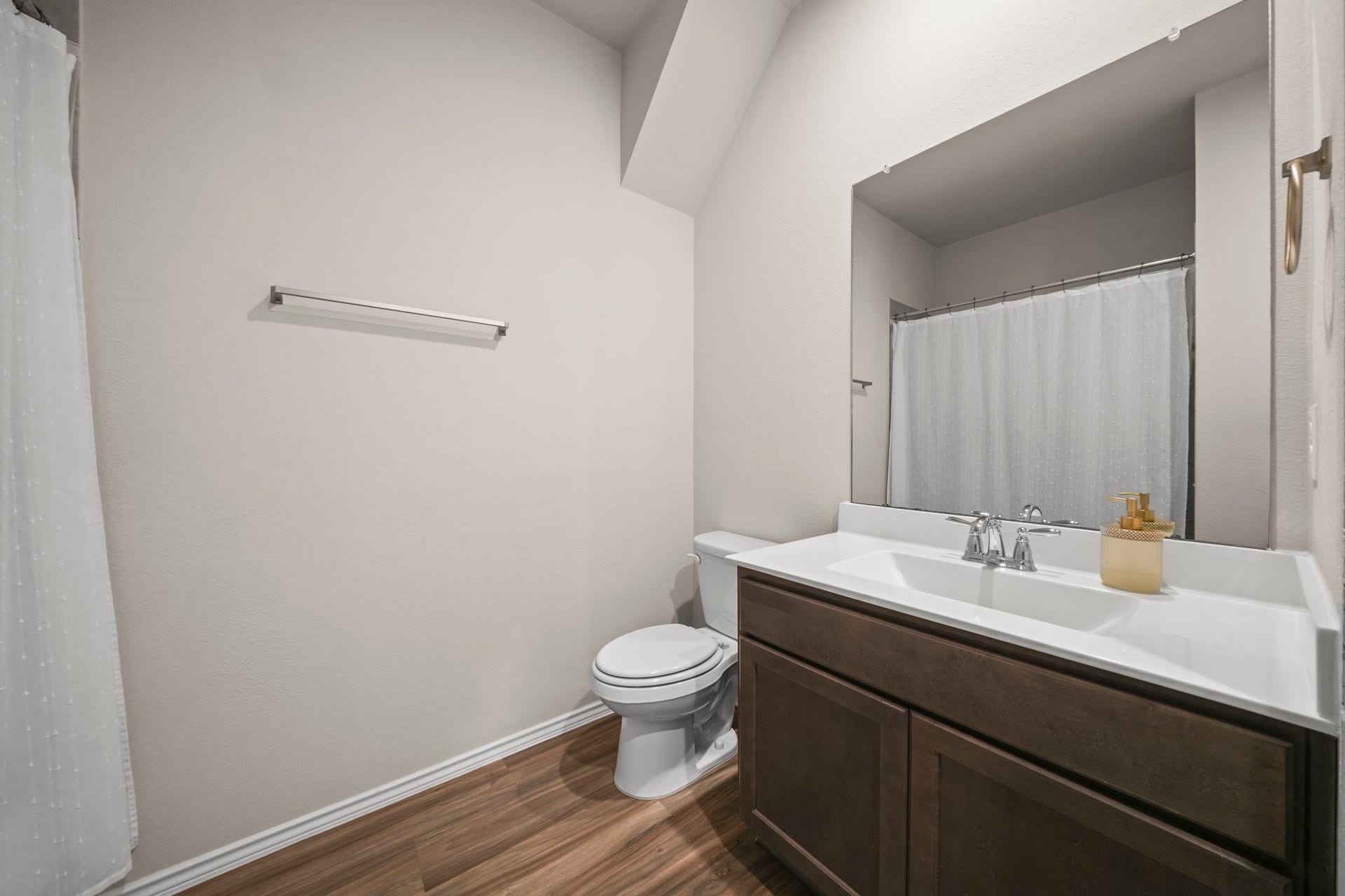 Conveniently located second bathroom with a clean, functional design, perfect for family and guests.