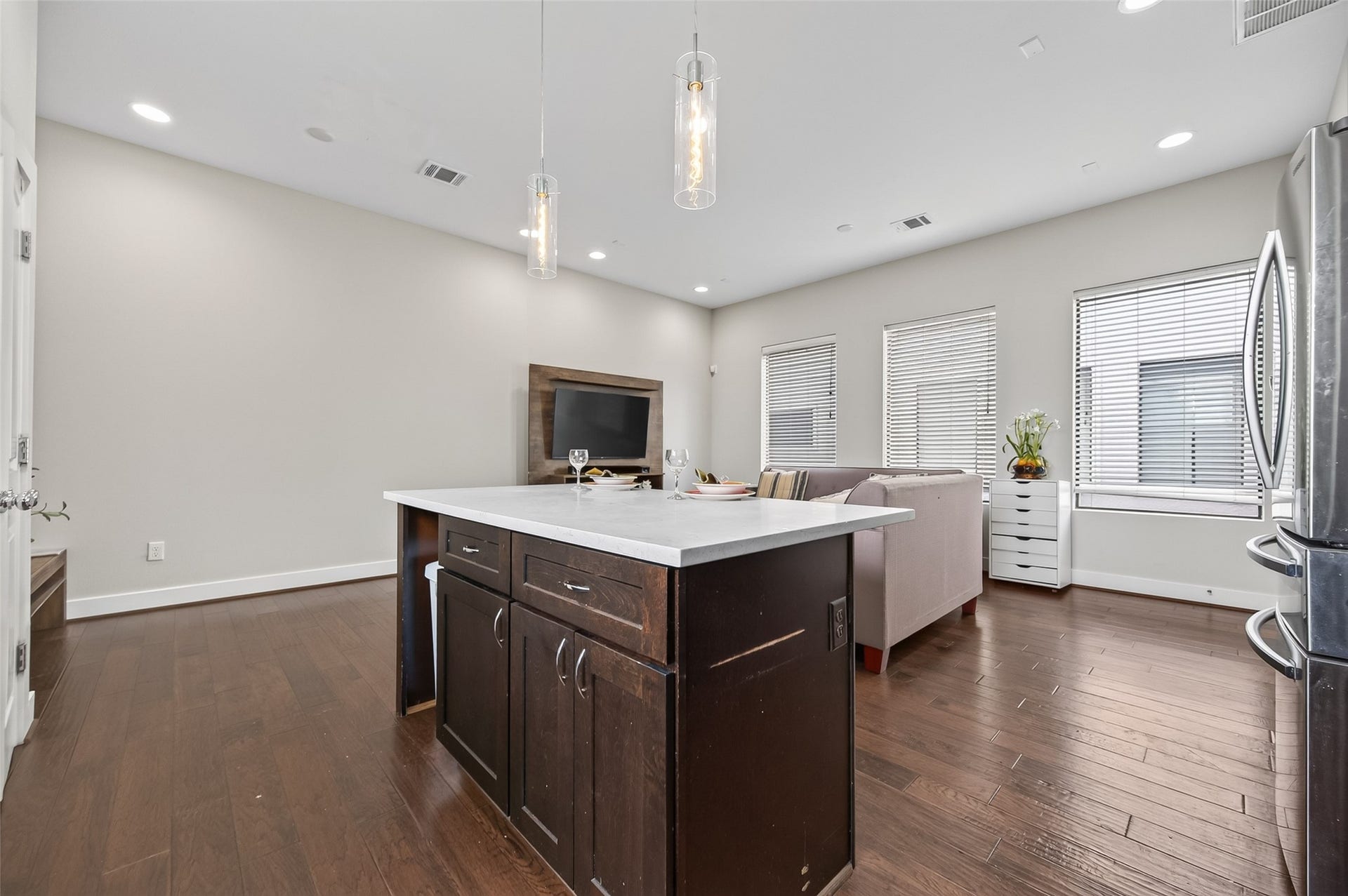 2805 Blodgett Street, #C, Houston, TX 77004 Bright and modern kitchen featuring sleek dark cabinets, a stainless steel dishwasher, and a chic subway tile backsplash, accented by large windows for natural light.