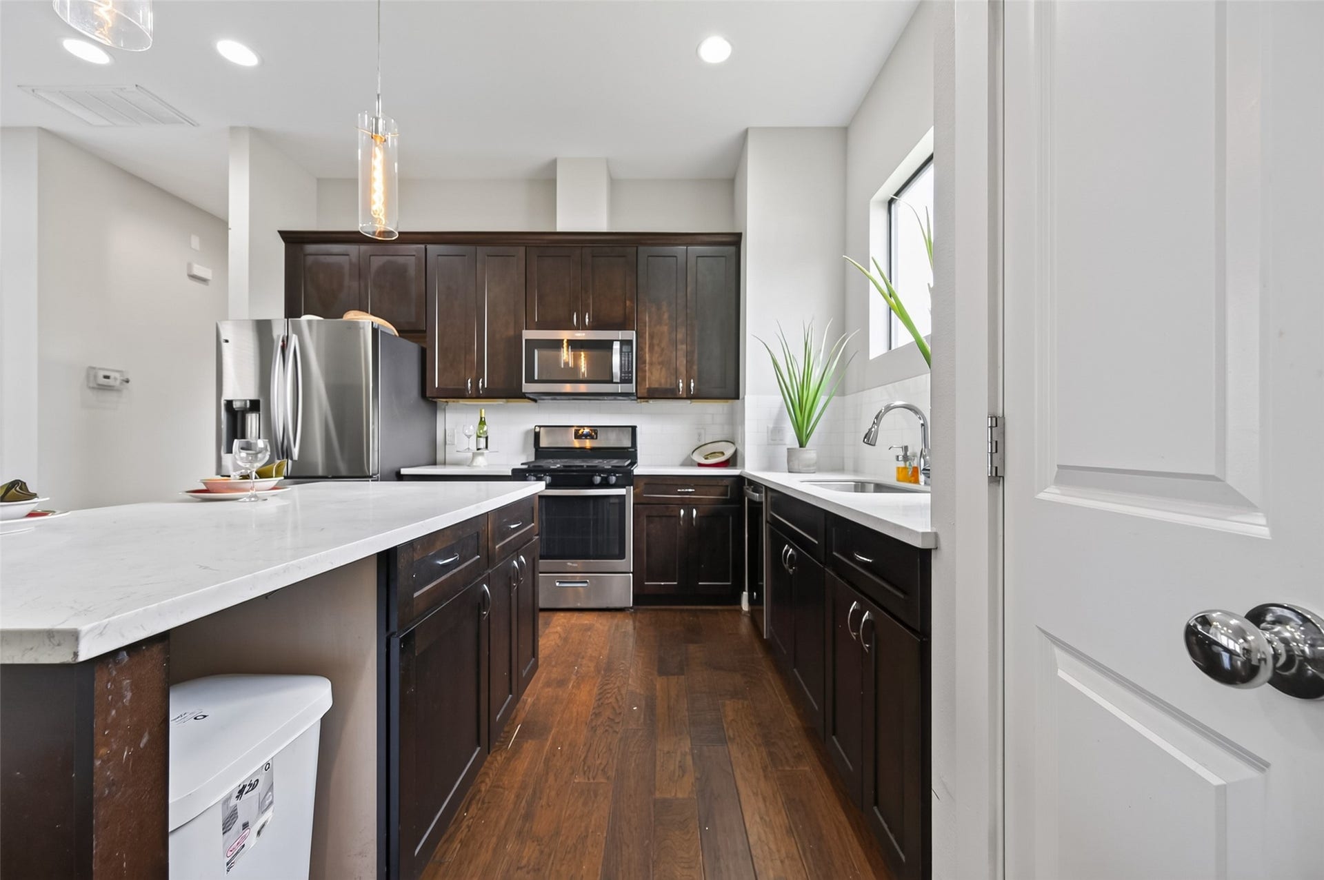 2805 Blodgett Street, #C, Houston, TX 77004 Bright and inviting space with elegant hardwood flooring and a high ceiling, featuring a versatile nook perfect for decor or storage.