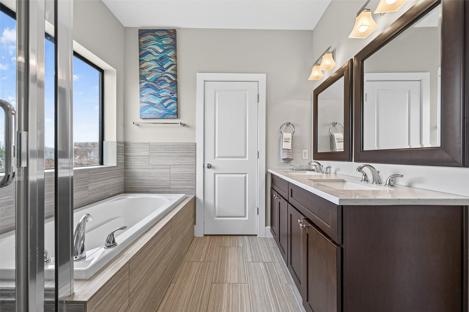 2805 Blodgett Street, #C, Houston, TX 77004 Elegant double vanity bathroom with marble countertops, rich wood cabinetry, and large framed mirrors, offering a blend of style and functionality.