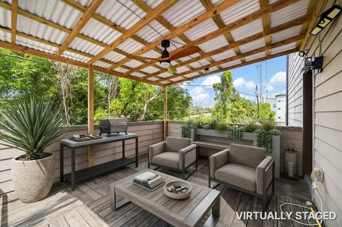 2805 Blodgett Street, #C, Houston, TX 77004 Charming covered deck with a stylish wooden ceiling and fan, perfect for enjoying outdoor relaxation amidst lush greenery.