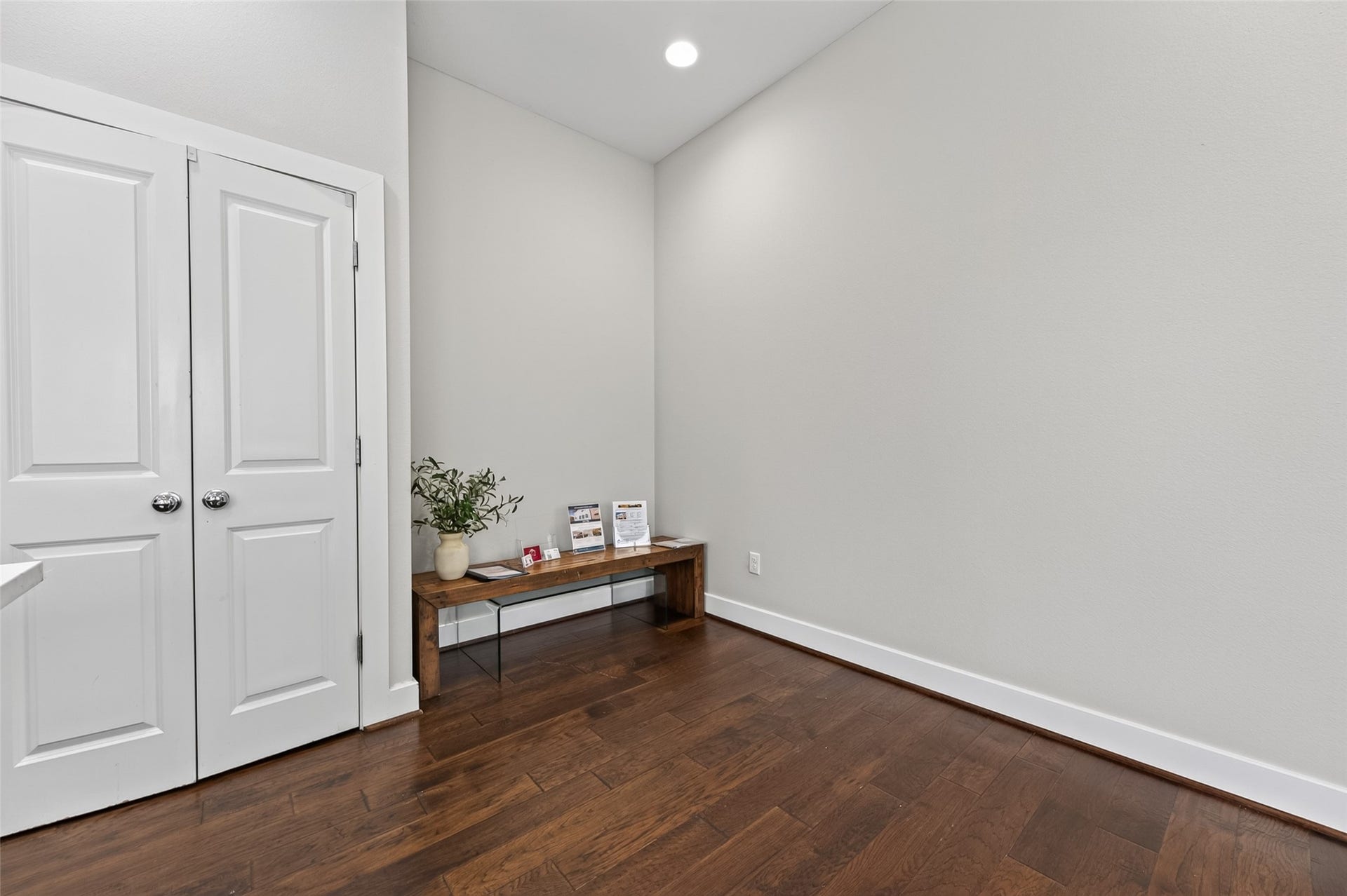 2805 Blodgett Street, #C, Houston, TX 77004 Bright and inviting living room featuring sleek hardwood floors, modern recessed lighting, and a stylish wall-mounted entertainment center. Large windows with blinds provide ample natural light, enhancing the open and airy feel.