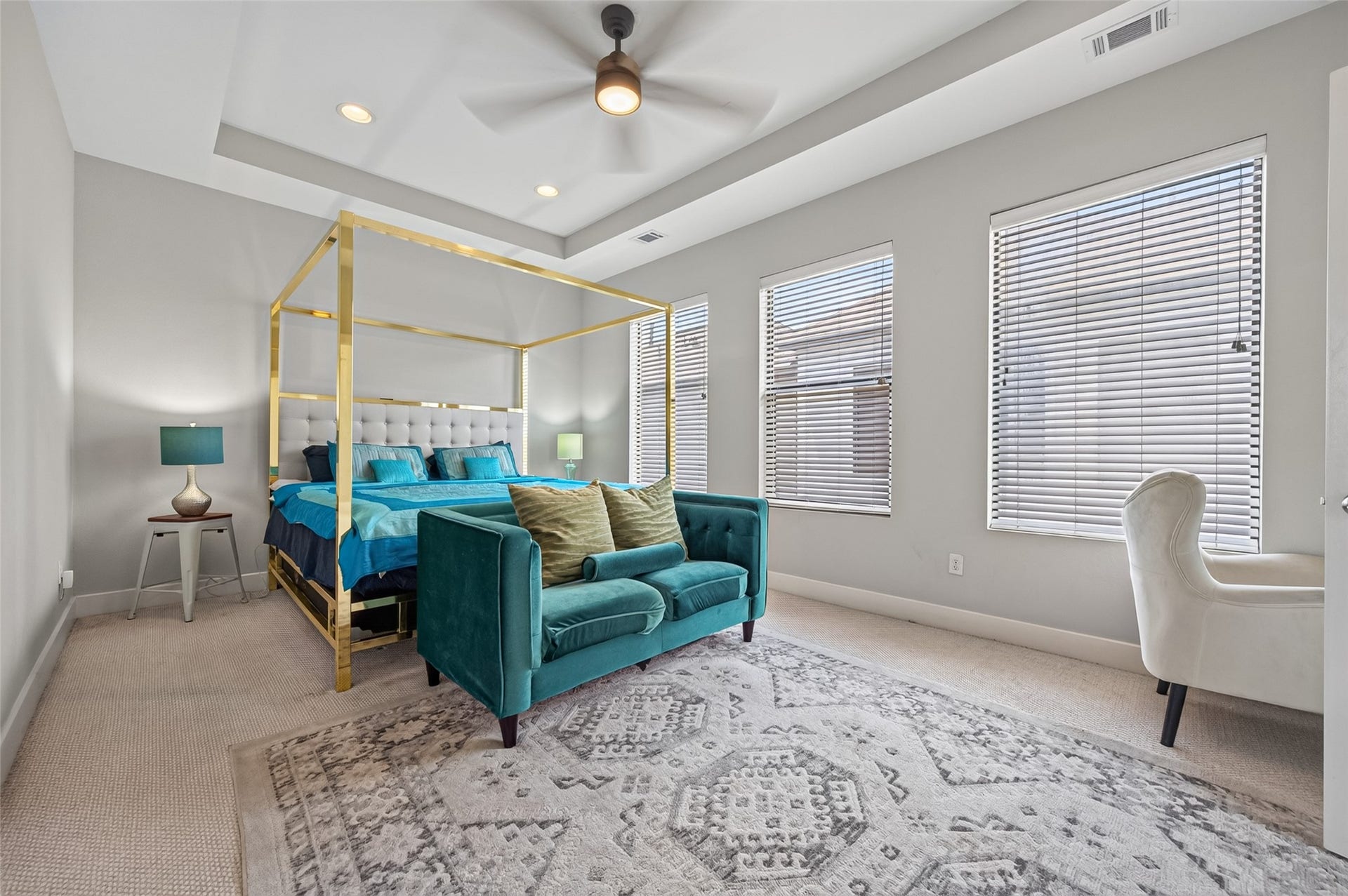 2805 Blodgett Street, #C, Houston, TX 77004 Spacious bedroom featuring a luxurious canopy bed with plush teal accents, complemented by a stylish area rug and abundant natural light.