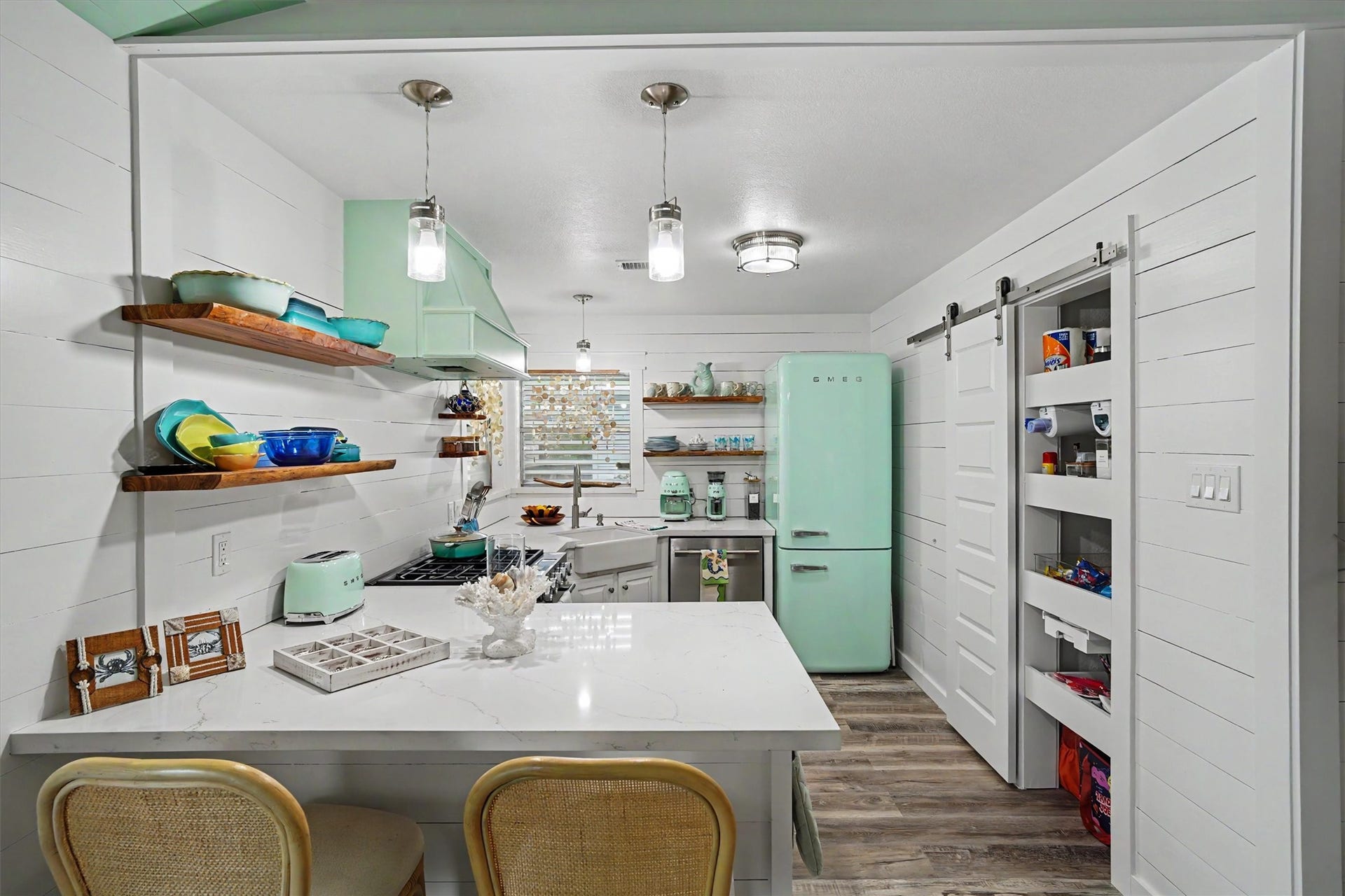Every inch of this updated kitchen was maximized for storage, style, and everyday convenienceincluding a pantry with pull-out shelves!