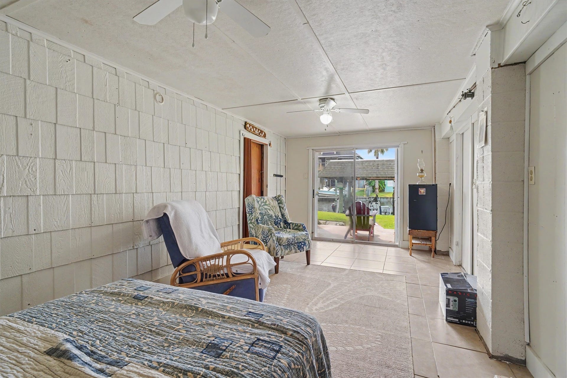 A versatile downstairs space with a sliding glass door and waterfront viewsperfect for an office, guest room, game room, or whatever your lifestyle needs
