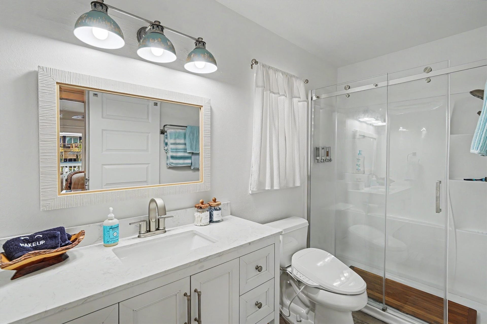 Recently remodeled with modern finishes and thoughtful design, this beautiful bathroom features a large walk-in shower that creates a spacious, relaxing retreat