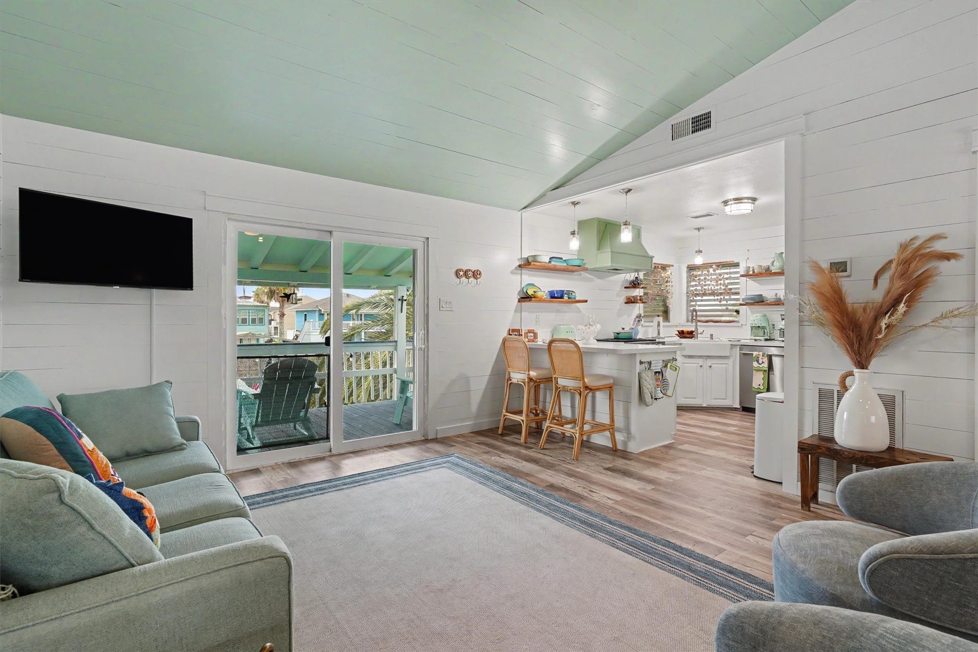 Beautiful LVP flooring, an open-concept design, and painted ceiling, create the perfect blend of relaxed coastal living and modern elegance