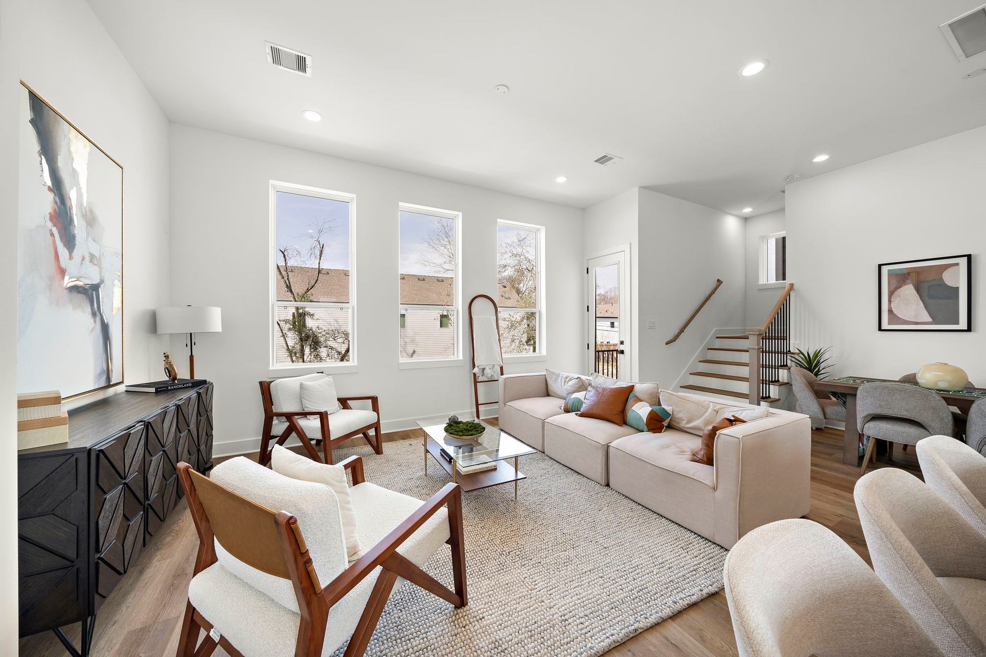 835 Elkhart Street, #E, Houston, TX 77091 Bright and inviting living area featuring large windows and an open layout perfect for relaxation and entertaining.