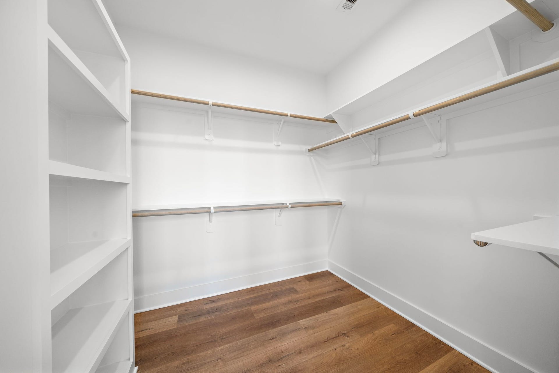 835 Elkhart Street, #E, Houston, TX 77091 Here's a spacious and well-organized primary closet, featuring ample shelving and hanging space to accommodate your entire wardrobe effortlessly.