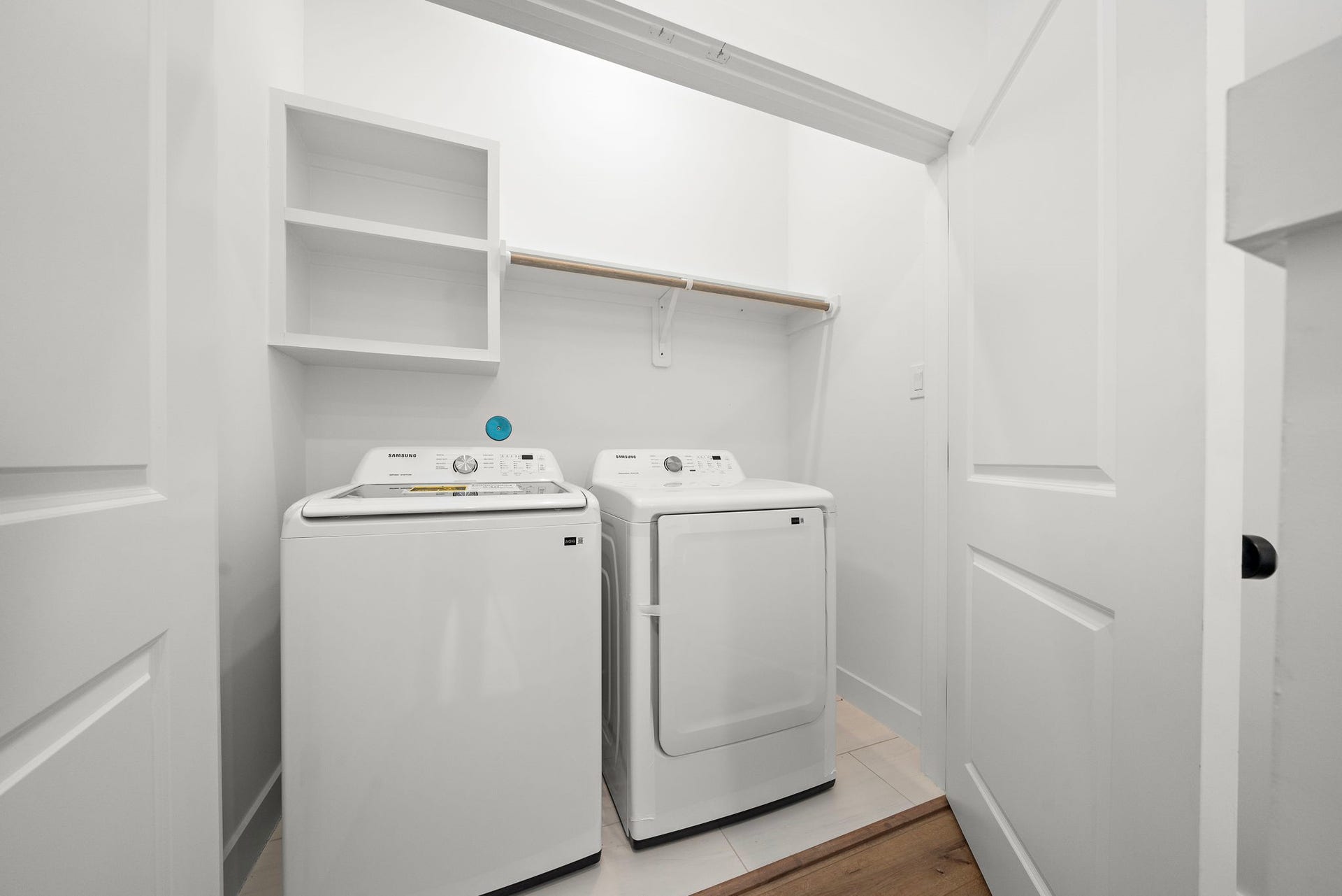 835 Elkhart Street, #E, Houston, TX 77091 This efficient laundry space features convenient shelving, and a minimalist design for easy organization.