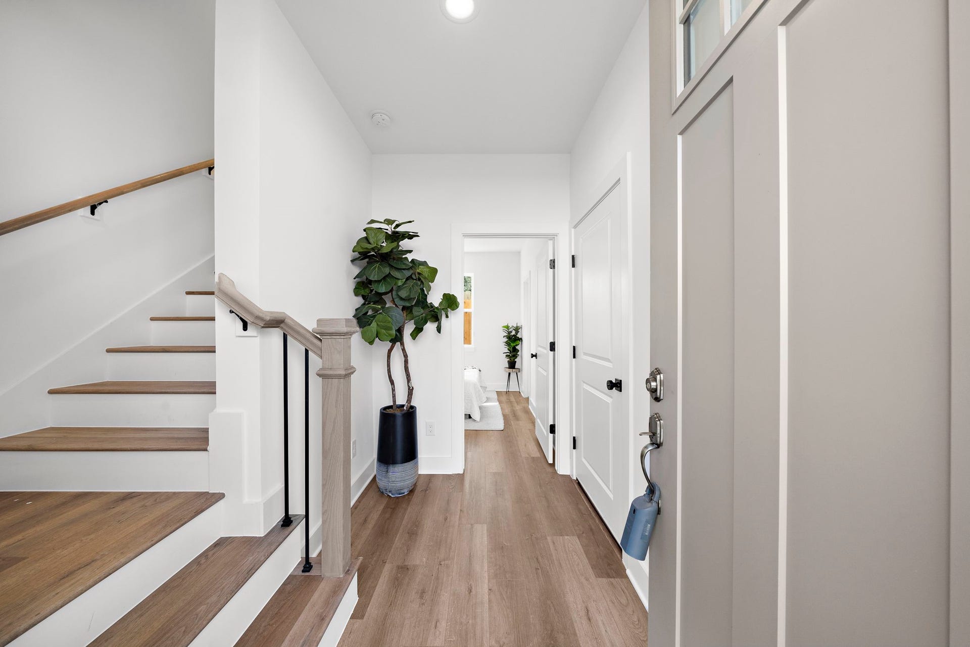 835 Elkhart Street, #E, Houston, TX 77091 Step into a bright and welcoming foyer, featuring sleek hardwood floors and modern finishes, seamlessly guiding you into the heart of the home.