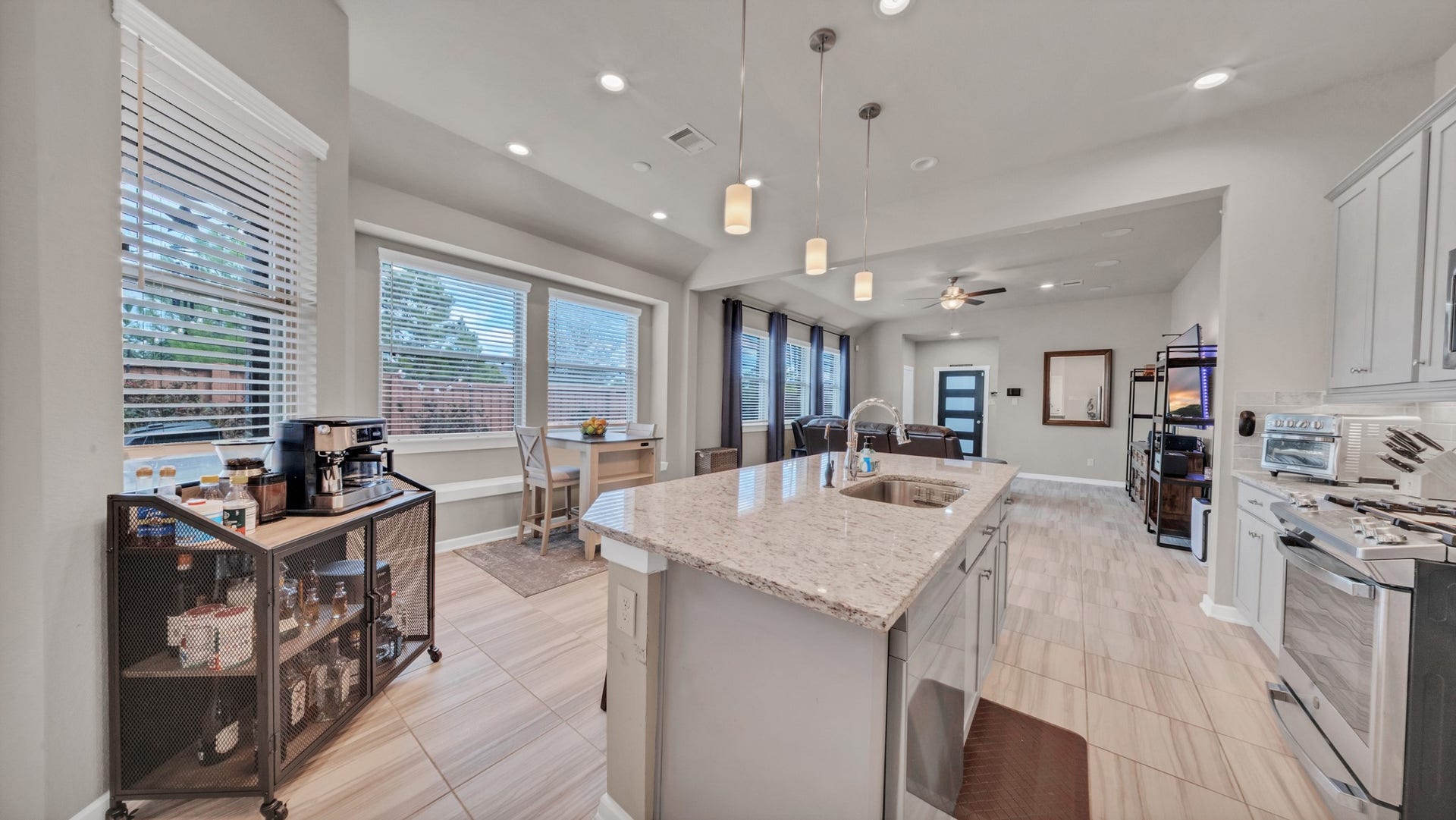 6123 Dovetail Cliff Court, Katy, TX 77493 Oversized island with seating, pendant lighting, and generous cabinetry for maximum functionality.