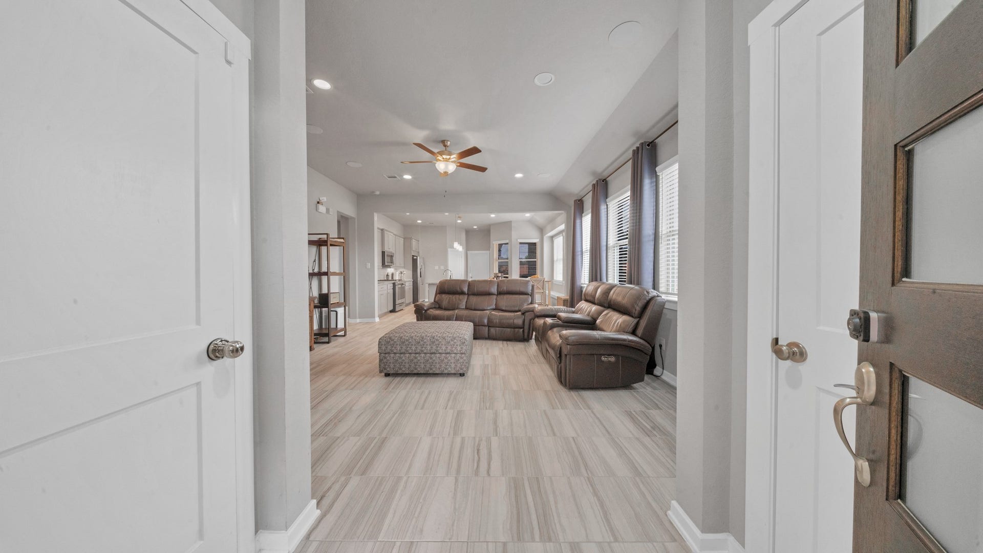 6123 Dovetail Cliff Court, Katy, TX 77493 Bright, open entry leading to spacious living and kitchen areas with tile throughout.