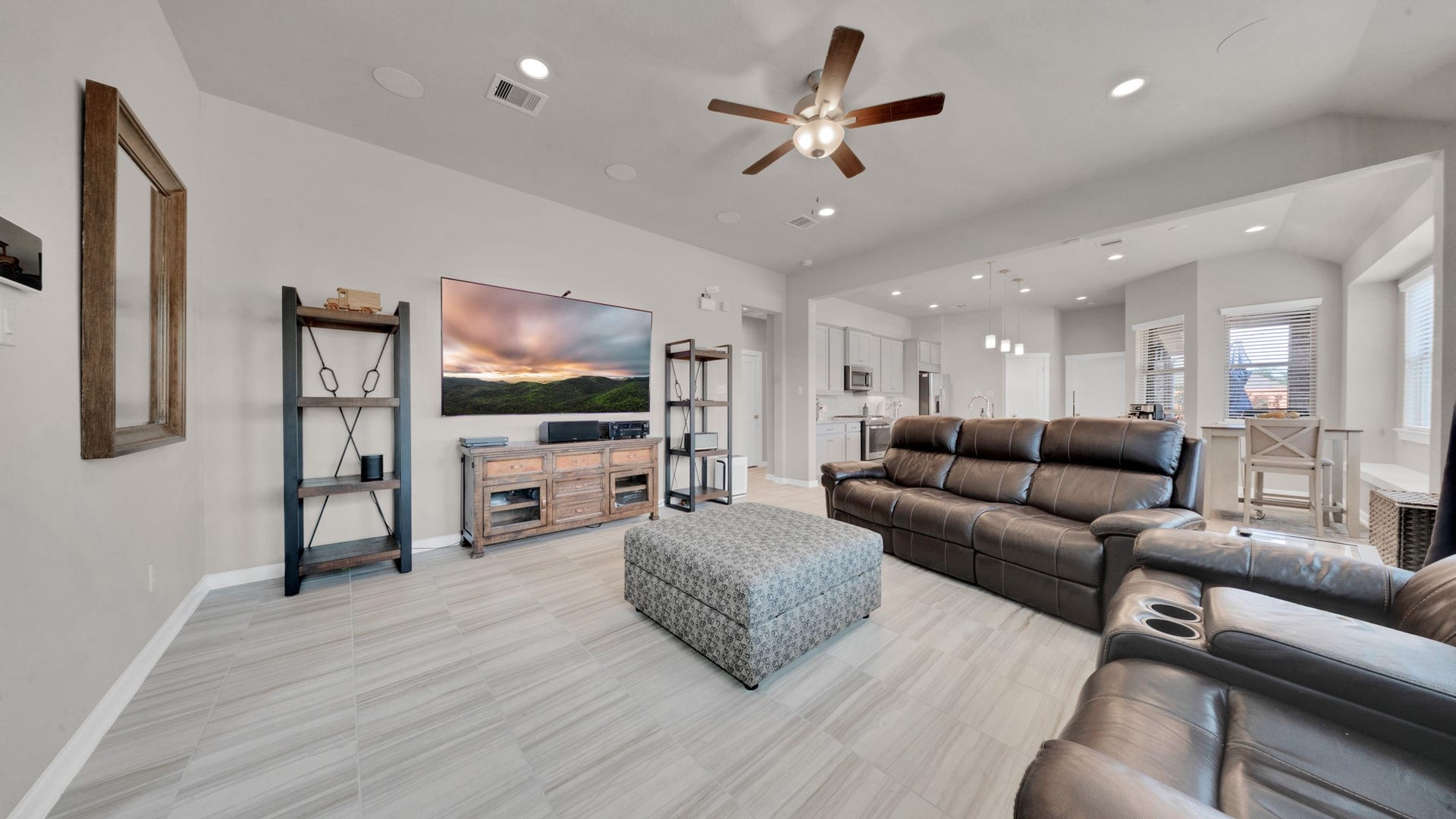 6123 Dovetail Cliff Court, Katy, TX 77493 Generous living space featuring large windows, neutral tones, and upgraded tile flooring.