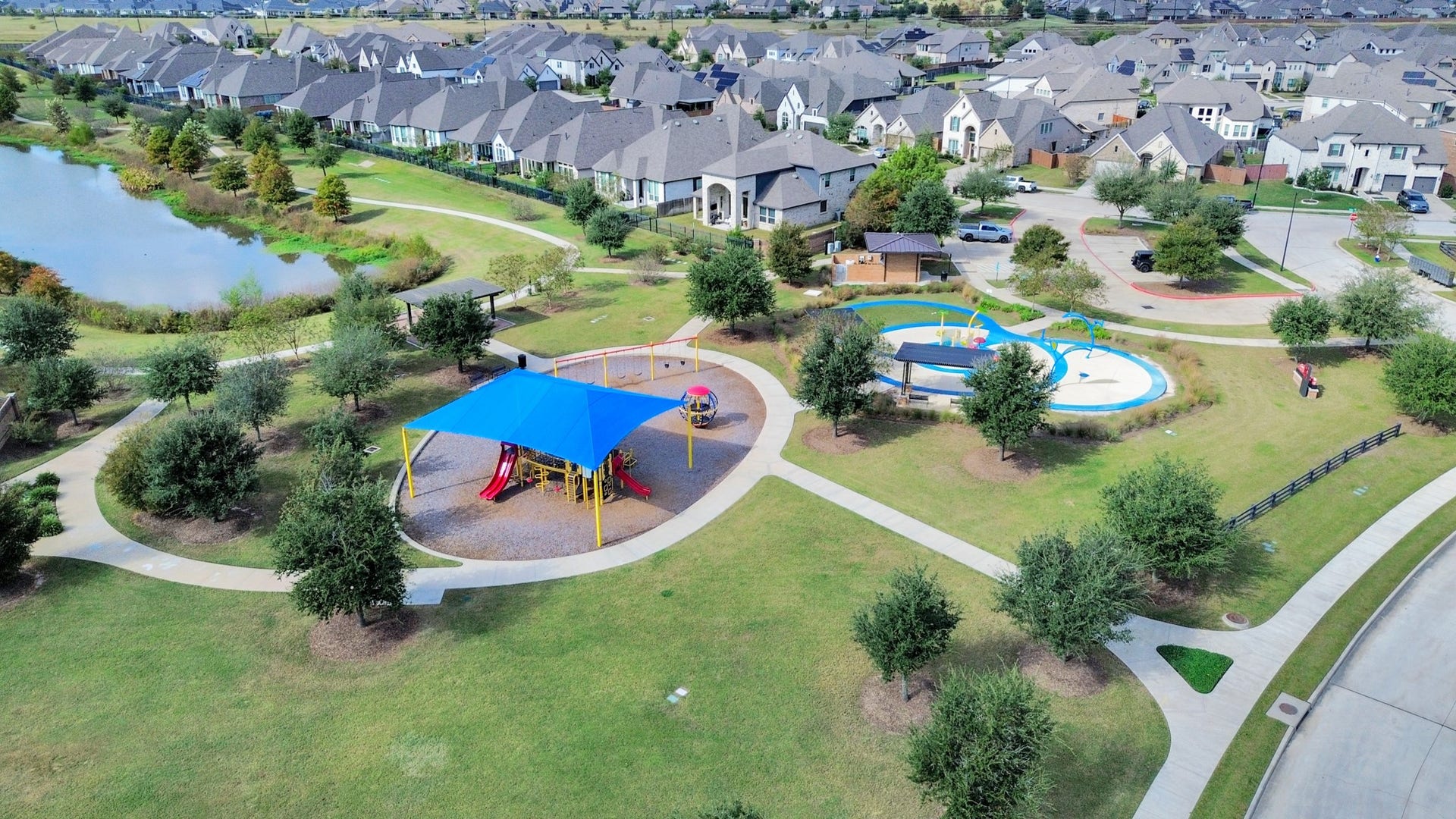 6123 Dovetail Cliff Court, Katy, TX 77493 Neighborhood park with playground, splash pad, walking trails, and scenic lake views.