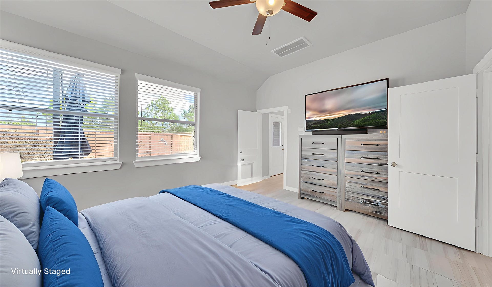 6123 Dovetail Cliff Court, Katy, TX 77493 Spacious primary bedroom with large windows offering abundant natural light and backyard views.