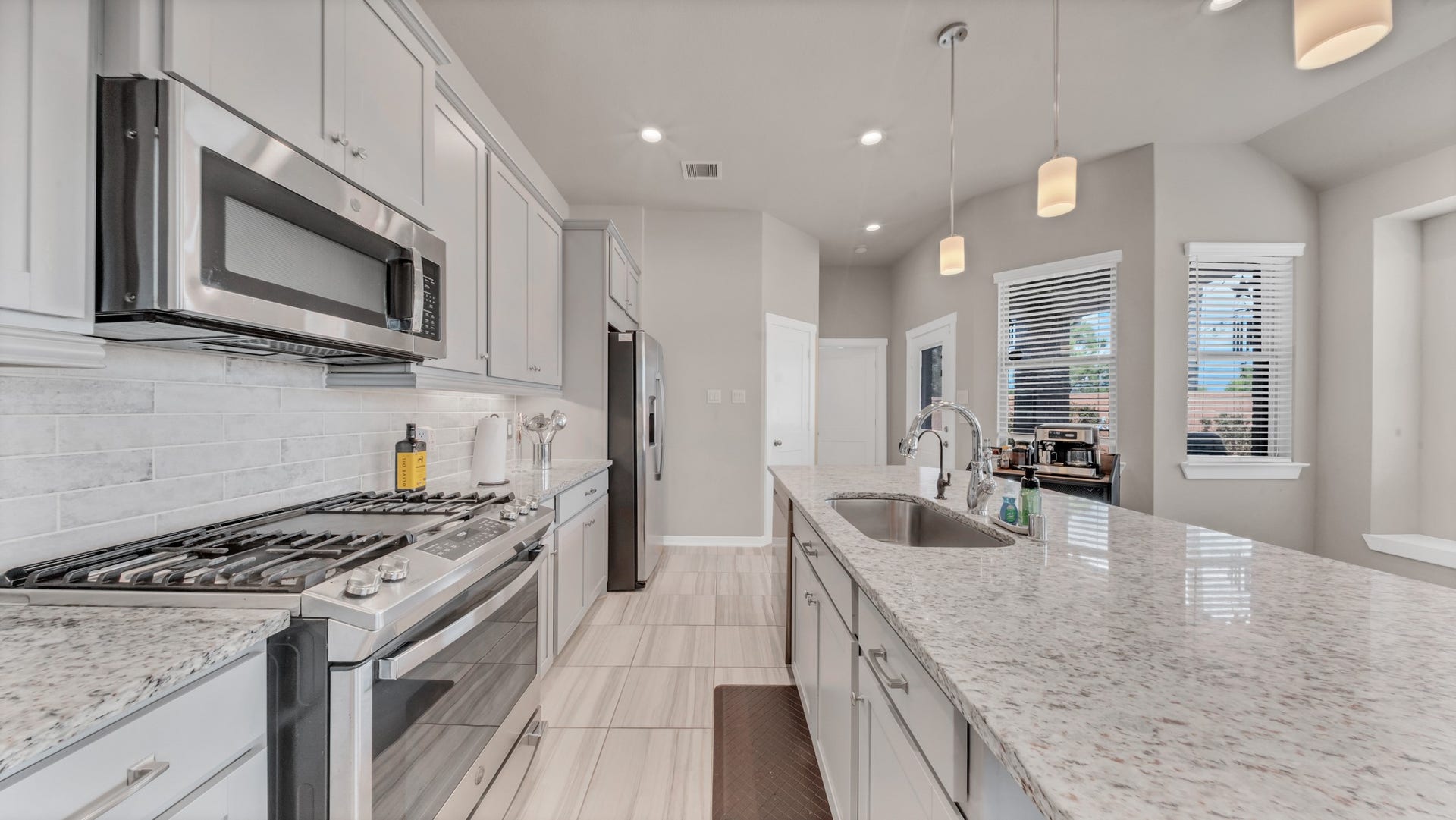 6123 Dovetail Cliff Court, Katy, TX 77493 Expansive island and open layout provide perfect connectivity to dining and living spaces.