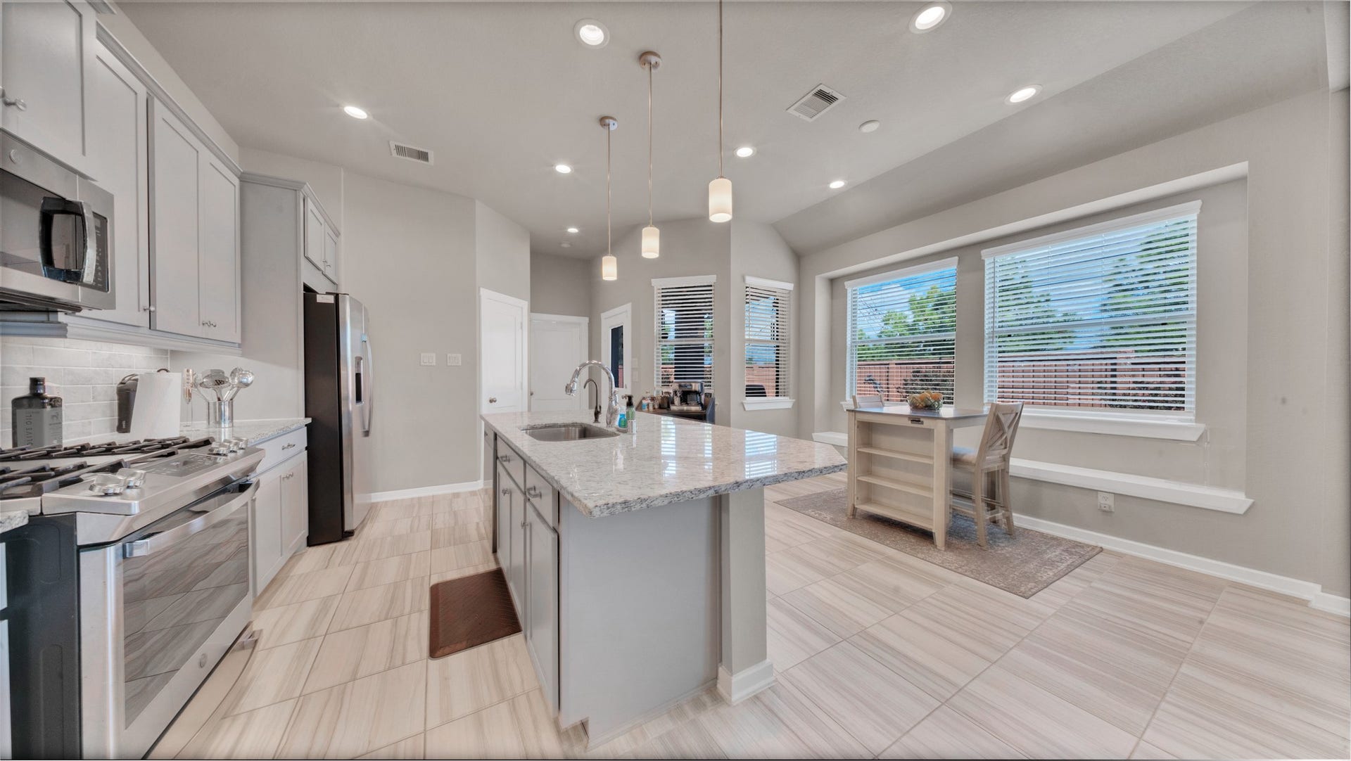 6123 Dovetail Cliff Court, Katy, TX 77493 Modern stainless-steel appliances, gas range, and granite island ideal for cooking and entertaining.