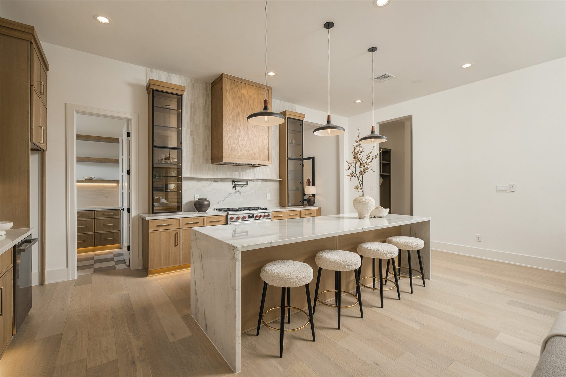 2109 McKean Drive, Houston, TX 77080 The kitchens generous scale and extended island seating create a true entertaining centerpiece, while the open layout maintains an effortless connection to the surrounding living spaces.