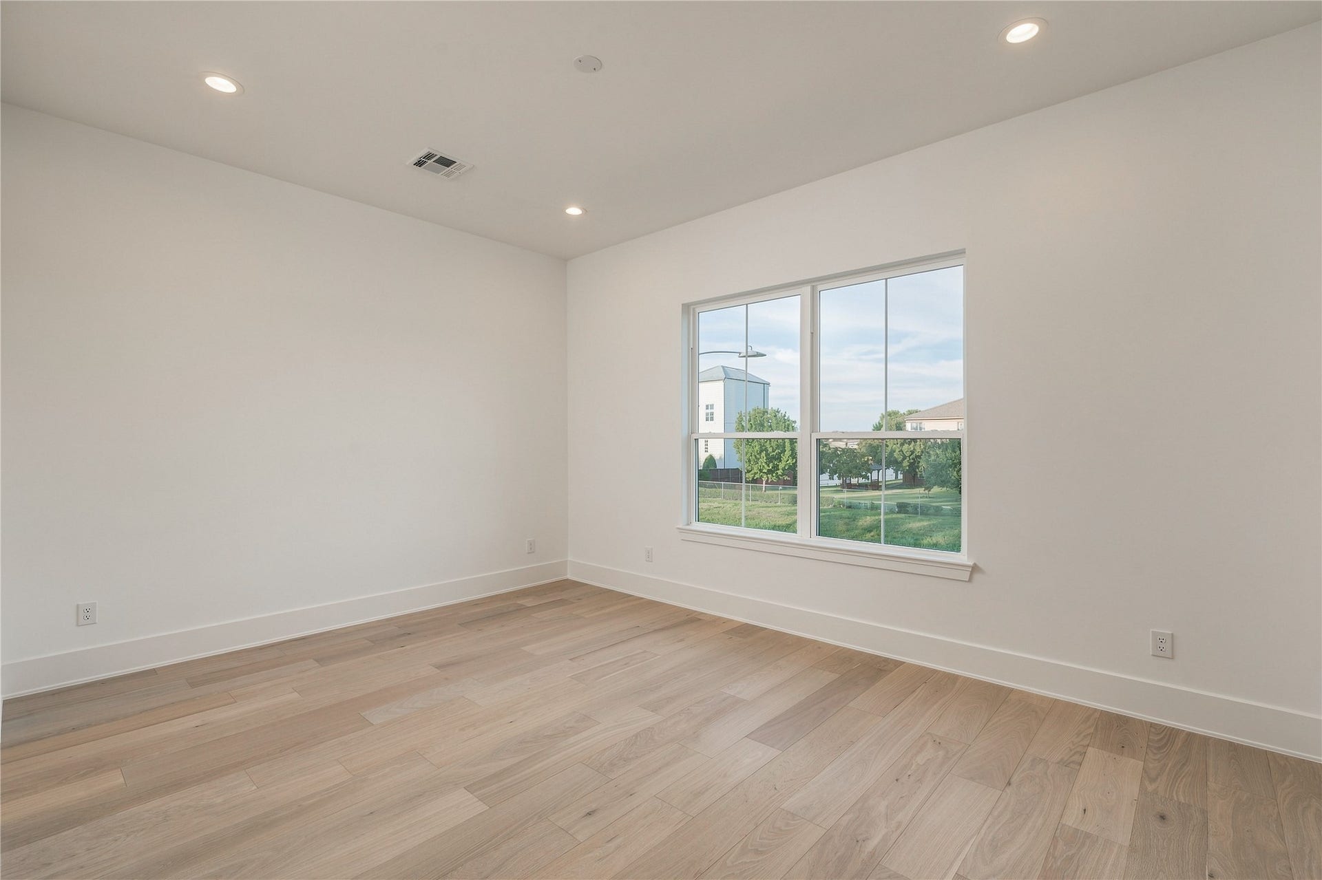 2109 McKean Drive, Houston, TX 77080 A generously proportioned secondary bedroom offers flexibility for a variety of layouts, with a wide window bringing in natural light and views toward the backyard.