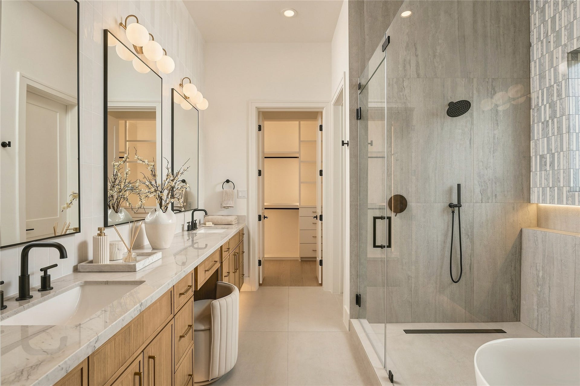 2109 McKean Drive, Houston, TX 77080 The primary bath delivers a spa-like experience with a generous dual vanity, dedicated makeup station, and an oversized frameless glass shower with a ceiling-mounted rainfall showerhead.