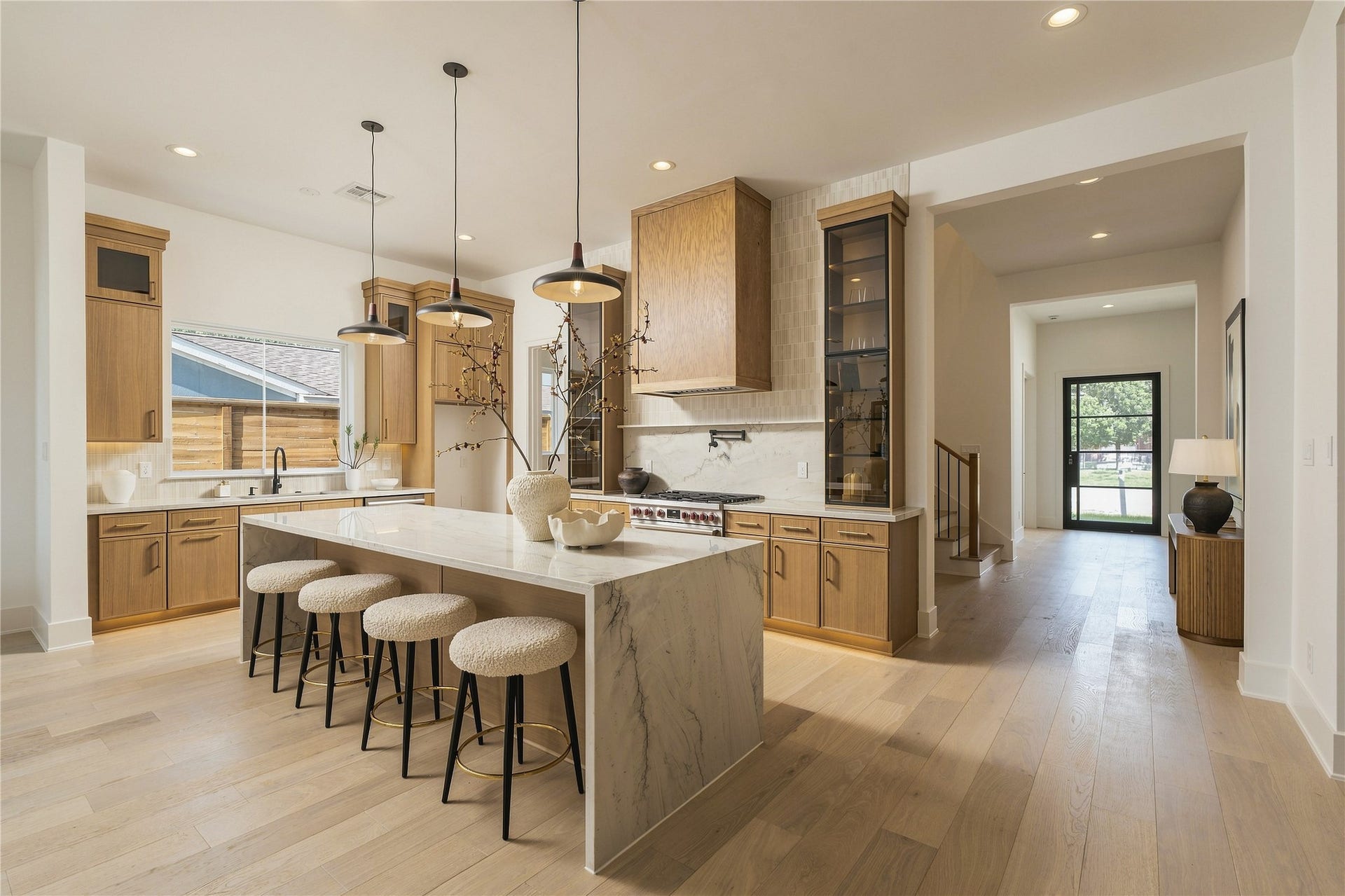 2109 McKean Drive, Houston, TX 77080 The kitchen makes an immediate statement with imported Mount Blanc Quartzite, custom cabinetry, and a dramatic oversized island, creating a natural centerpiece for both everyday living and entertaining.